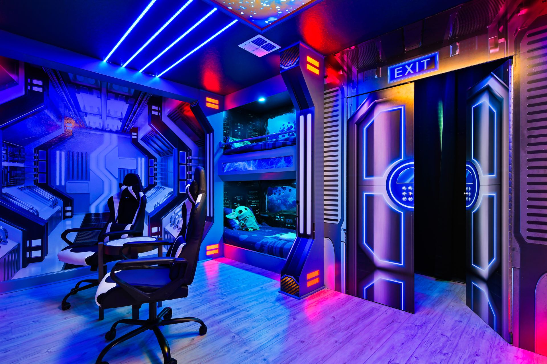 Futuristic space-themed bedroom featuring LED ceiling lights, immersive wall murals, gaming chairs, and custom-built bunk beds styled like spaceship pods.