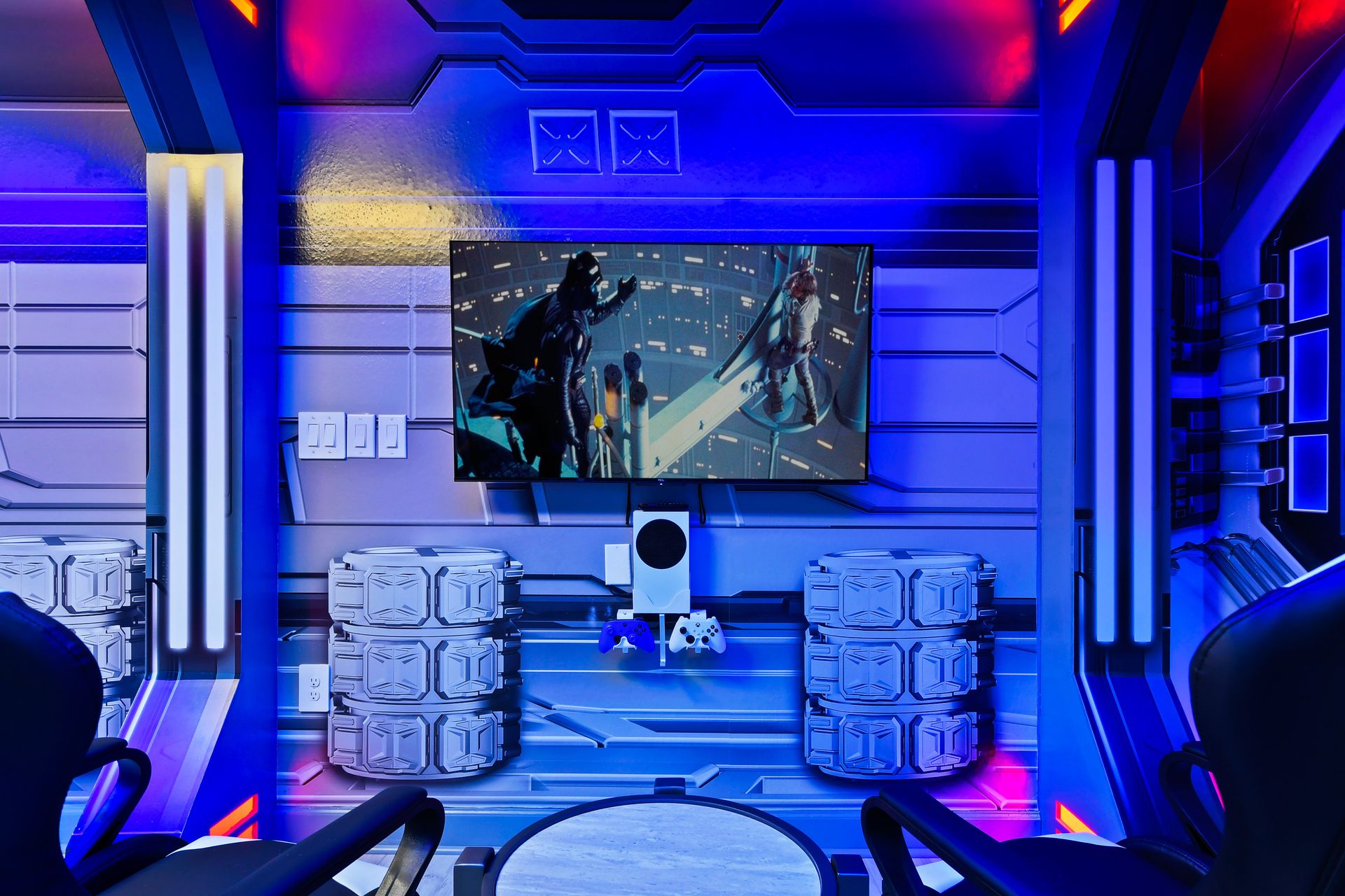 Immersive space-themed gaming station with LED lighting, Xbox, and wall-mounted TV.