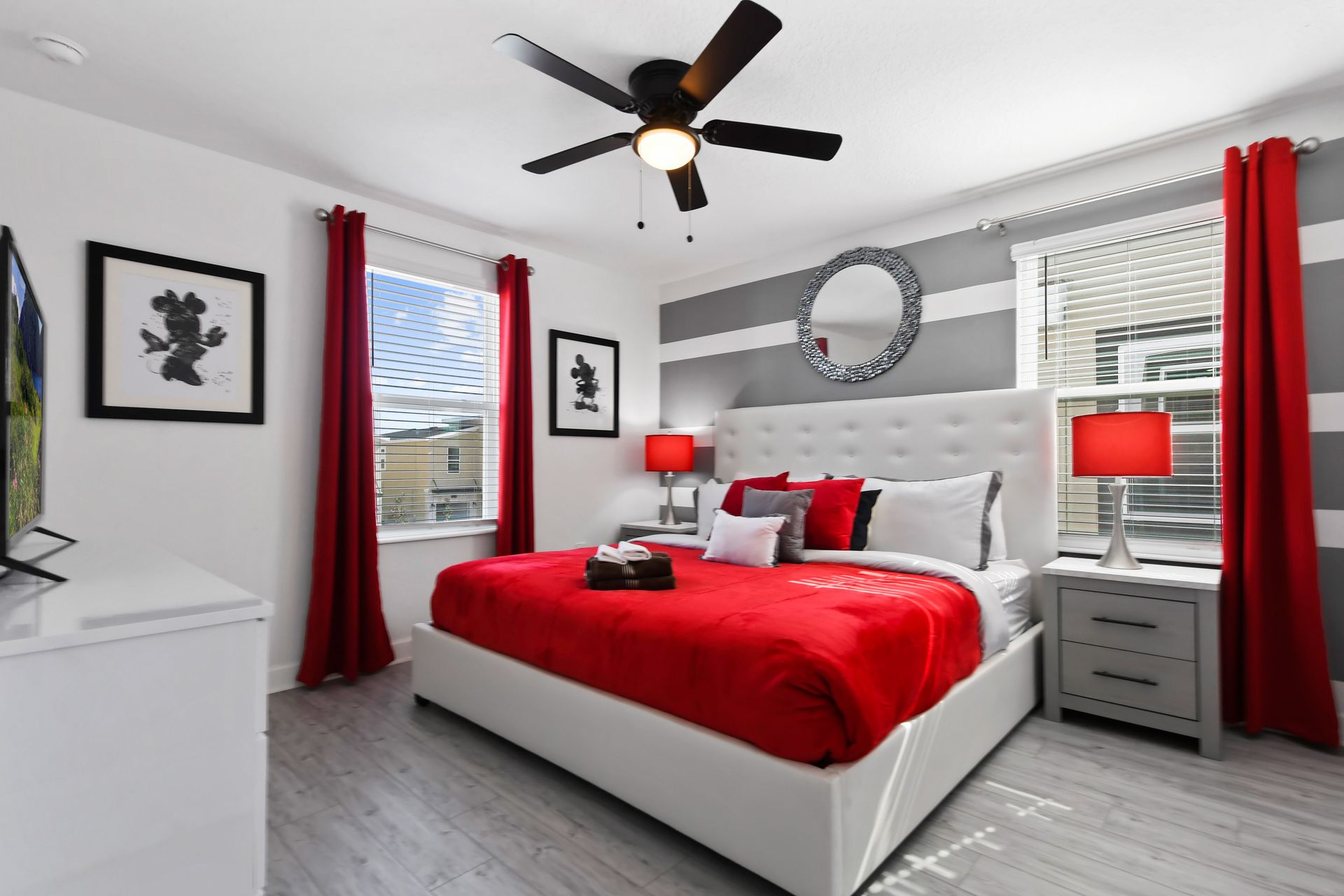 Vibrant red and white bedroom with bold stripes, king bed, and modern flair.