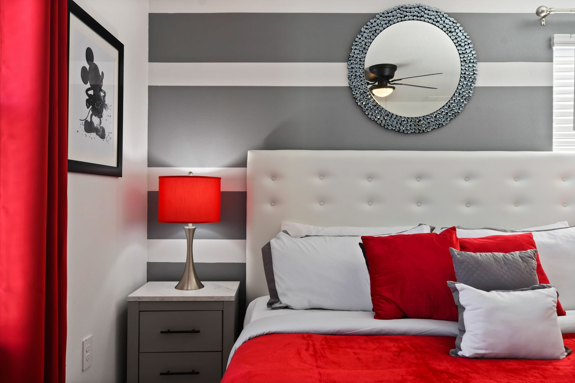 Vibrant red and white bedroom with bold stripes, king bed, and modern flair.