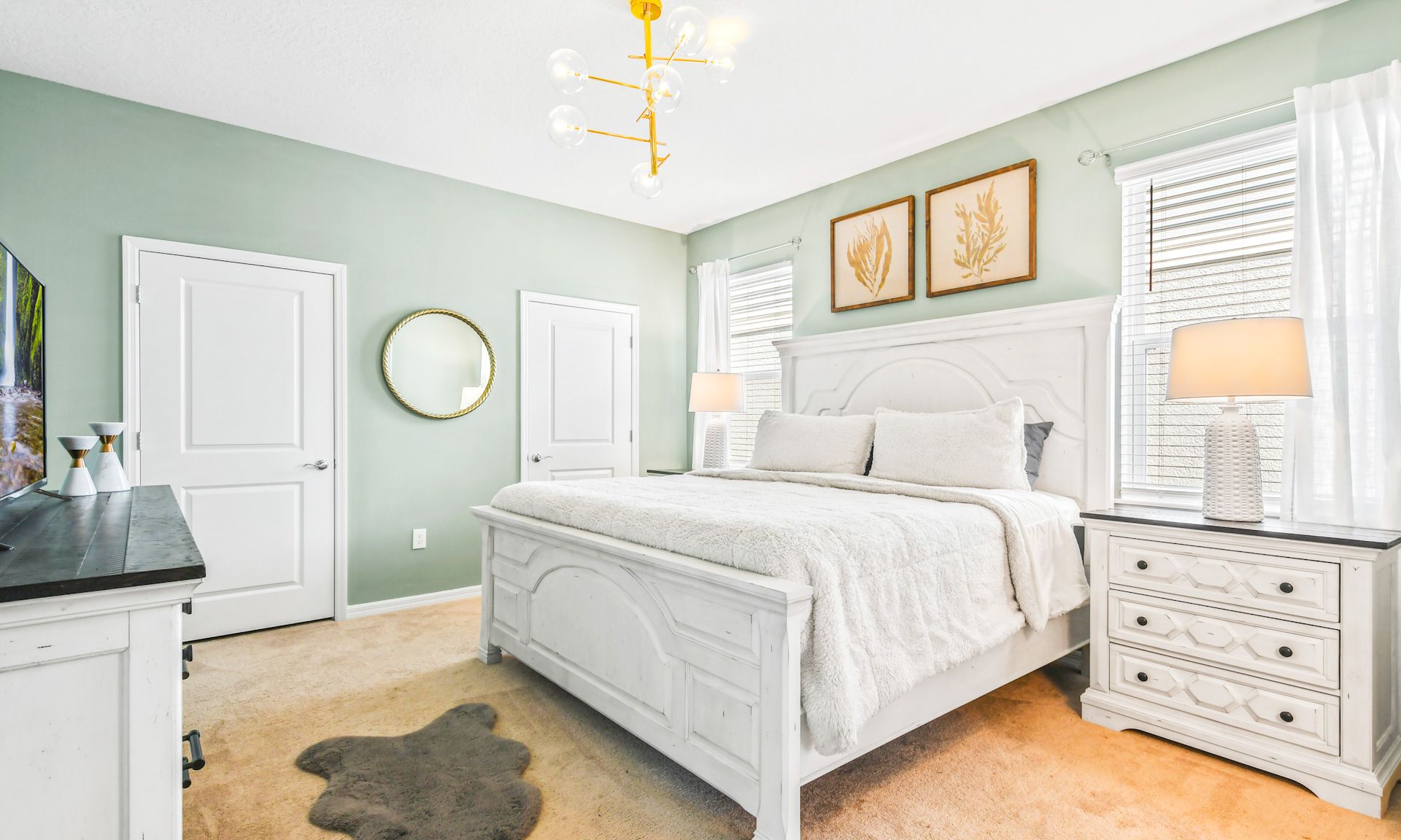 Serene bedroom with king bed, soft linens, coastal decor, and natural light for a relaxing retreat.