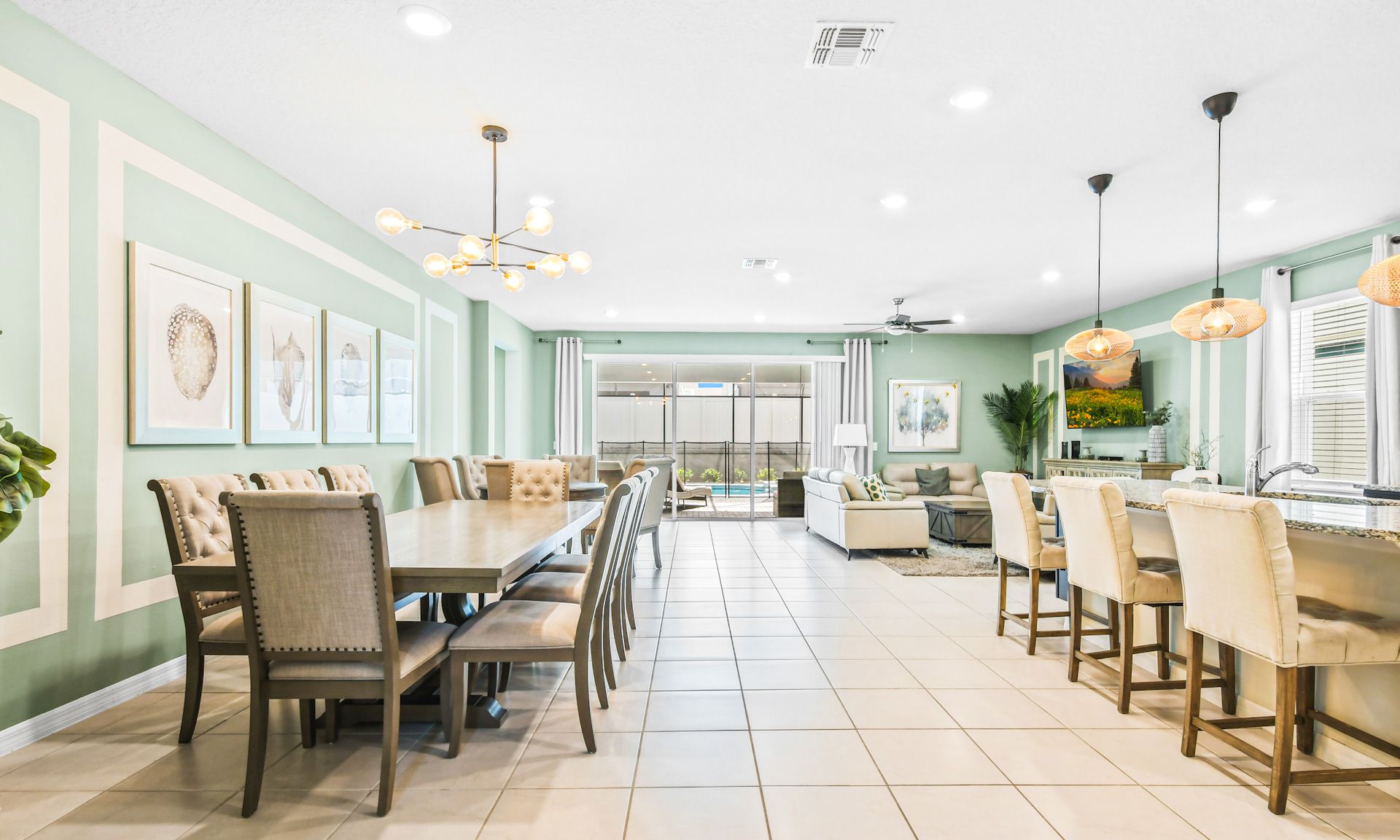 Spacious, stylish dining and living area with modern decor, natural light, and pool view.