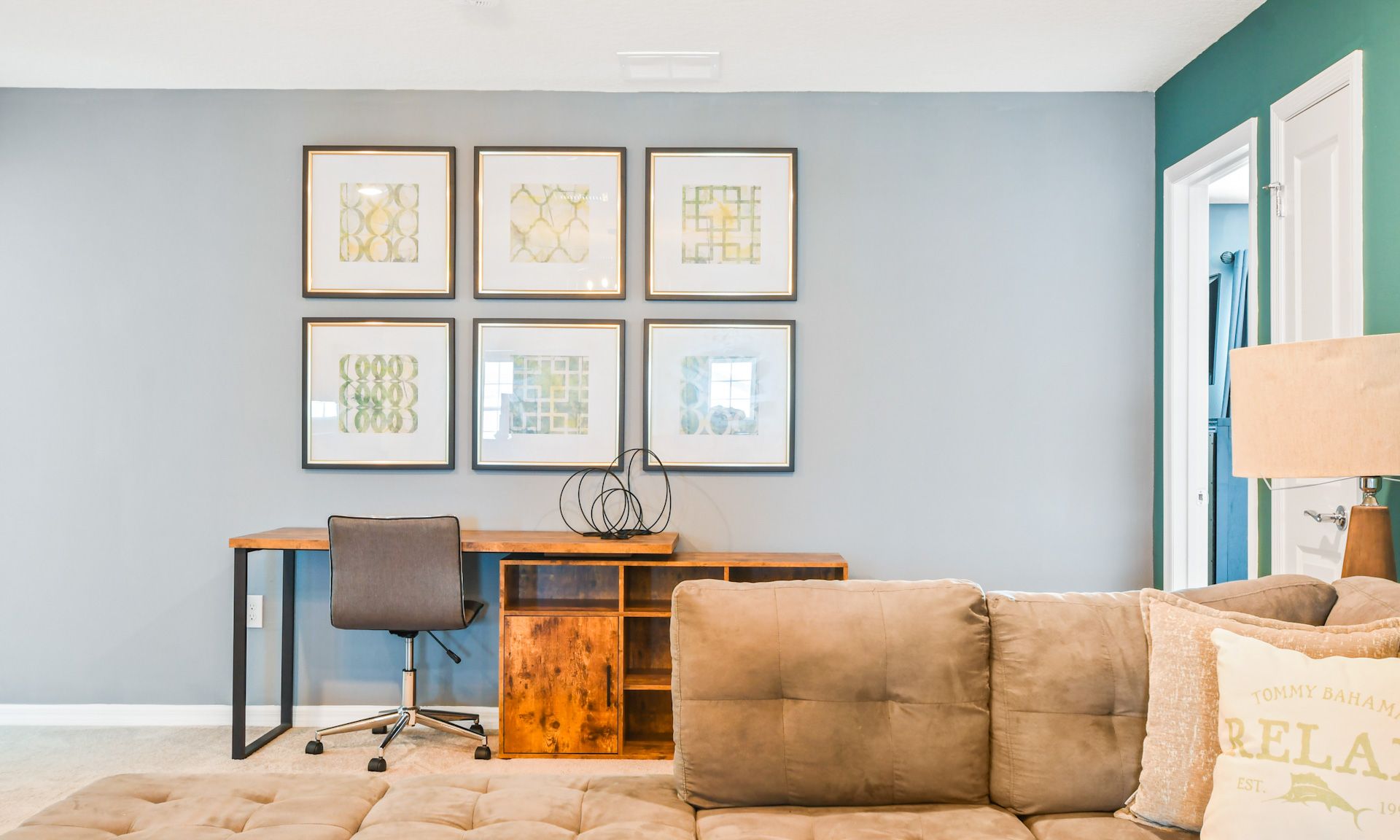 Cozy workspace with stylish desk, comfortable chair, and modern wall art for a relaxing vibe.