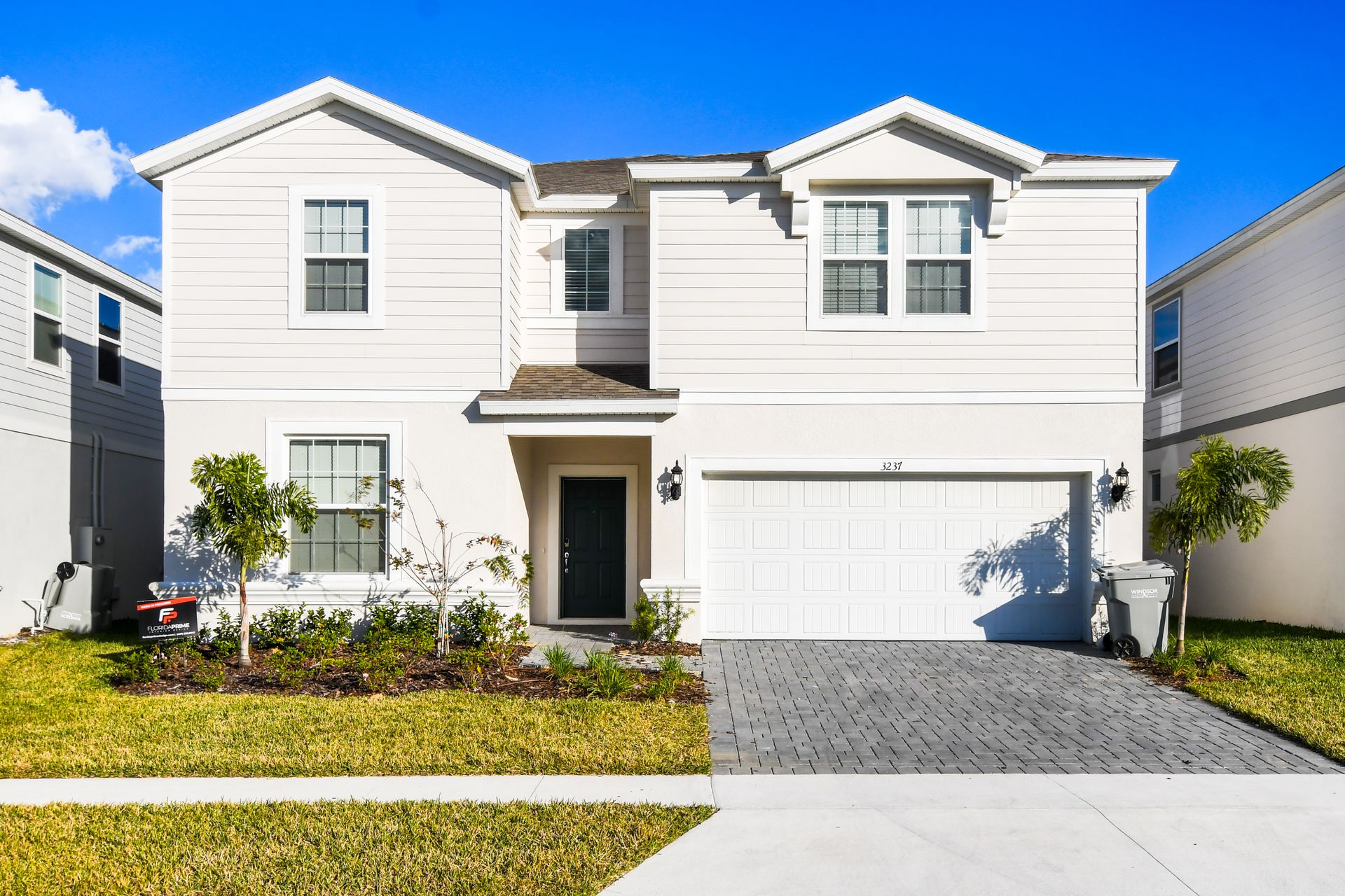 Beautiful modern family home with spacious garage, fresh landscaping, and bright vibe