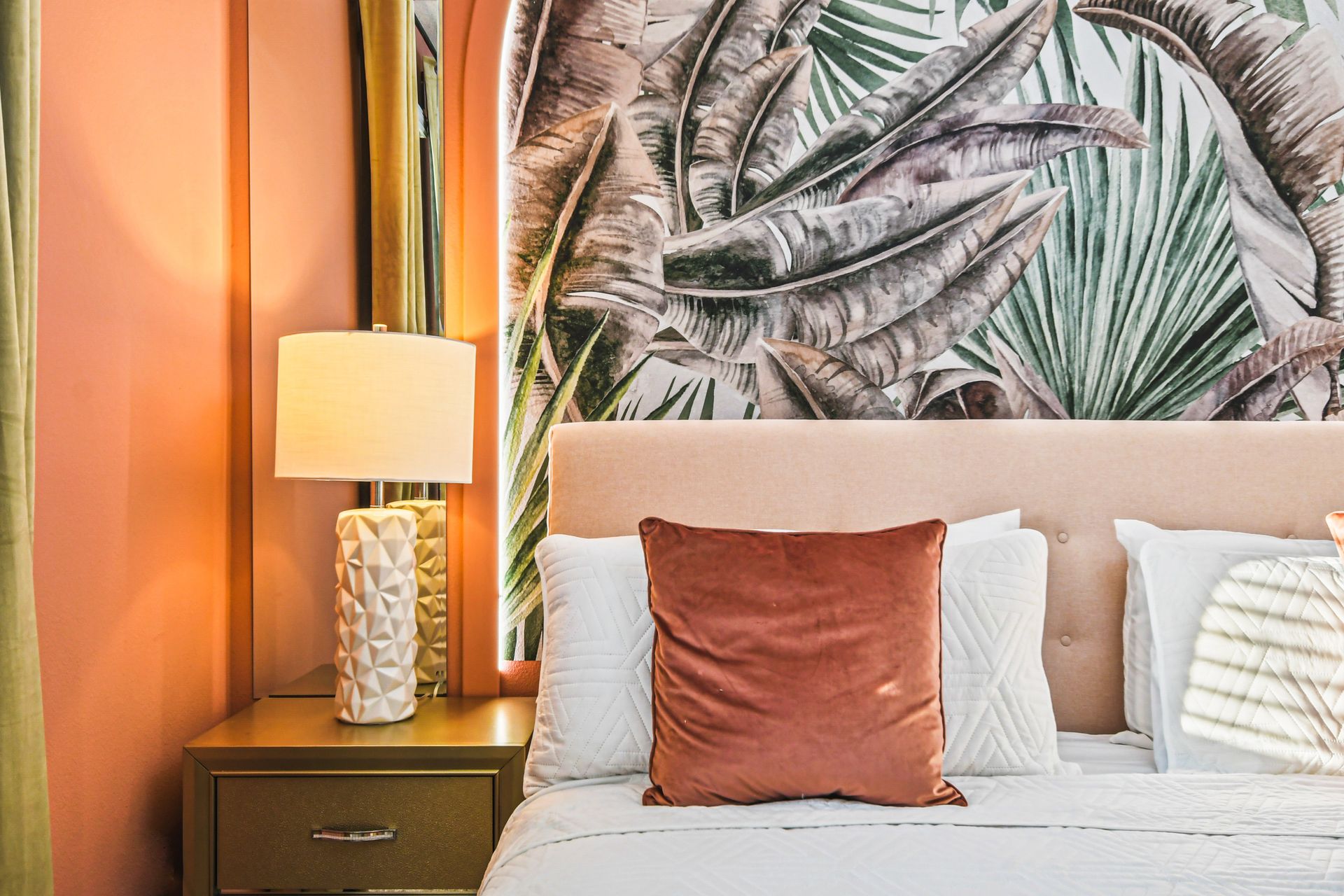 Elegant bedroom details with warm tones and tropical leaf design!