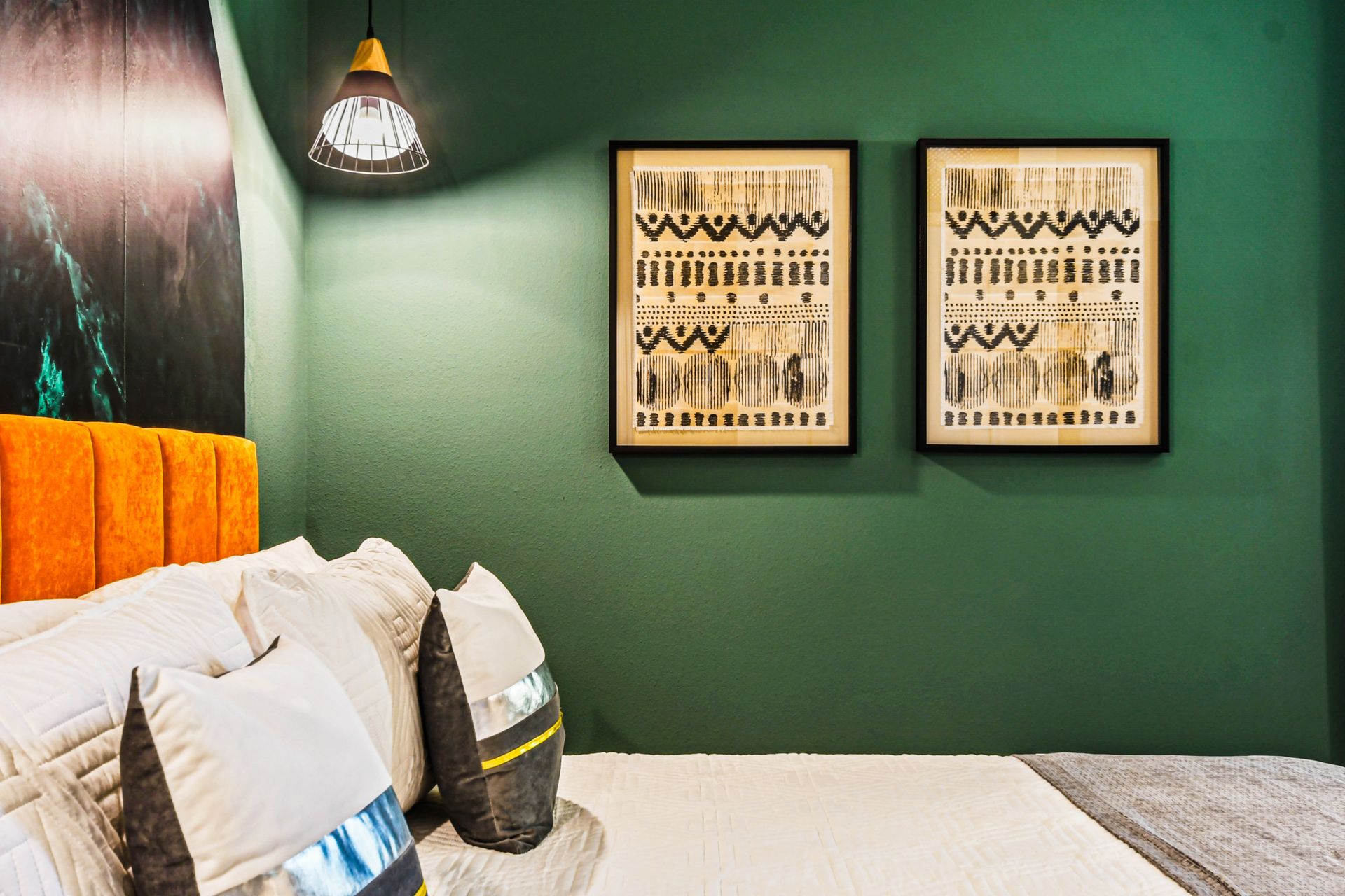 Stylish bedroom with artistic wall decor and vibrant accents!