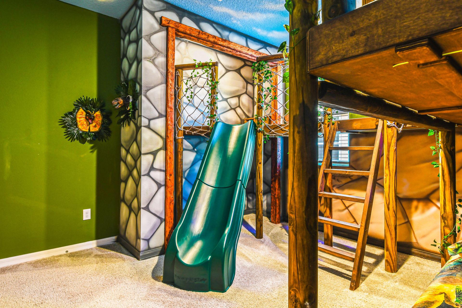 Jungle-themed kids' room with slide, bunk beds, and adventure vibes!