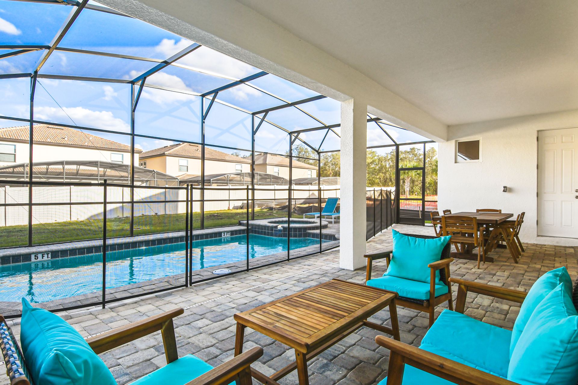 Relaxing patio with pool view, comfy seating, and outdoor dining area!