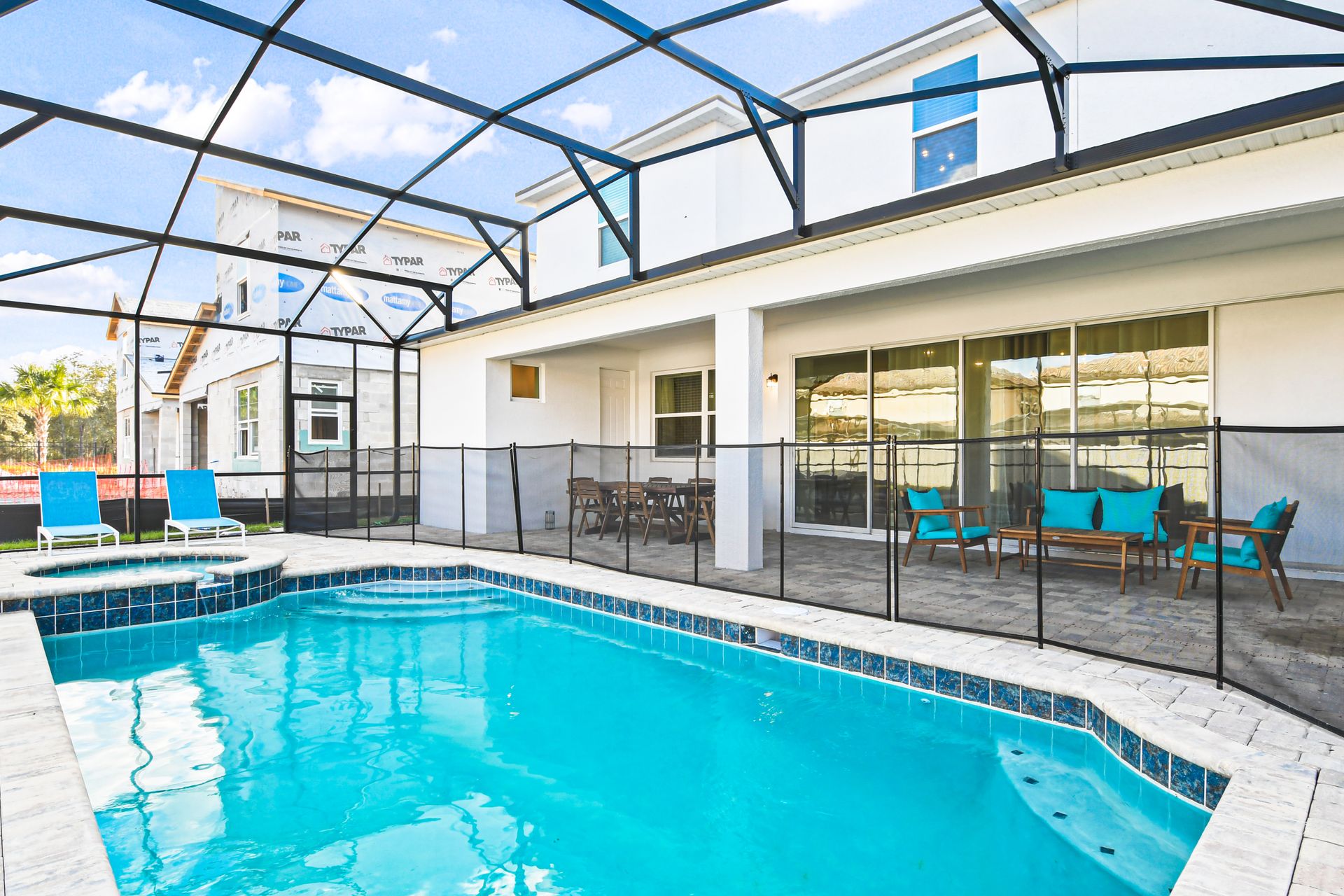 Spacious screened pool area with seating, dining, and a relaxing spa!