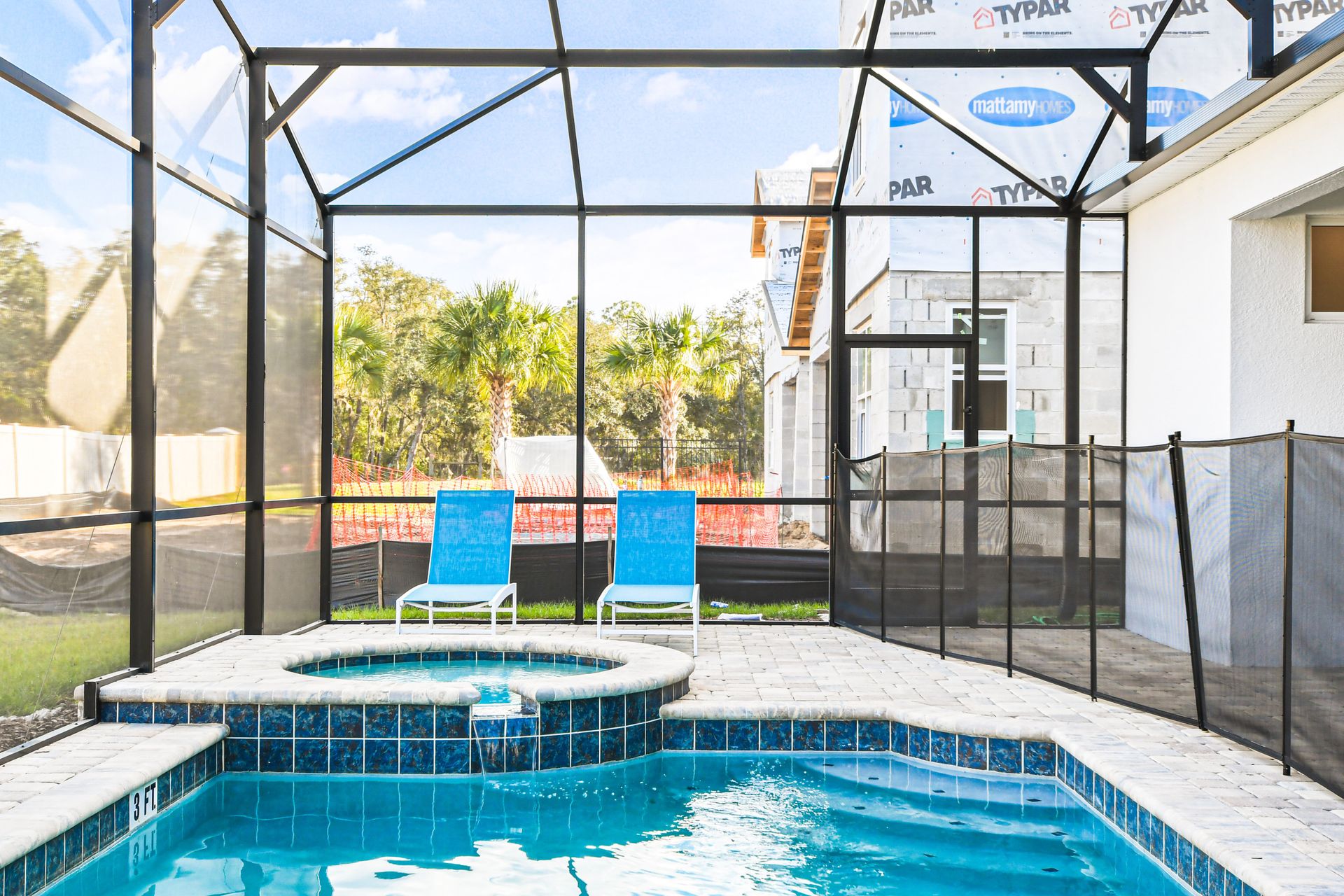 Relax by the screened pool and spa with sunny lounge chairs!