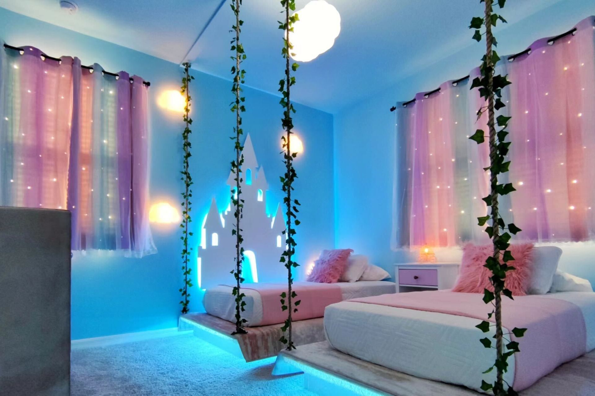 Whimsical princess-themed room with glowing beds and fairy lights!