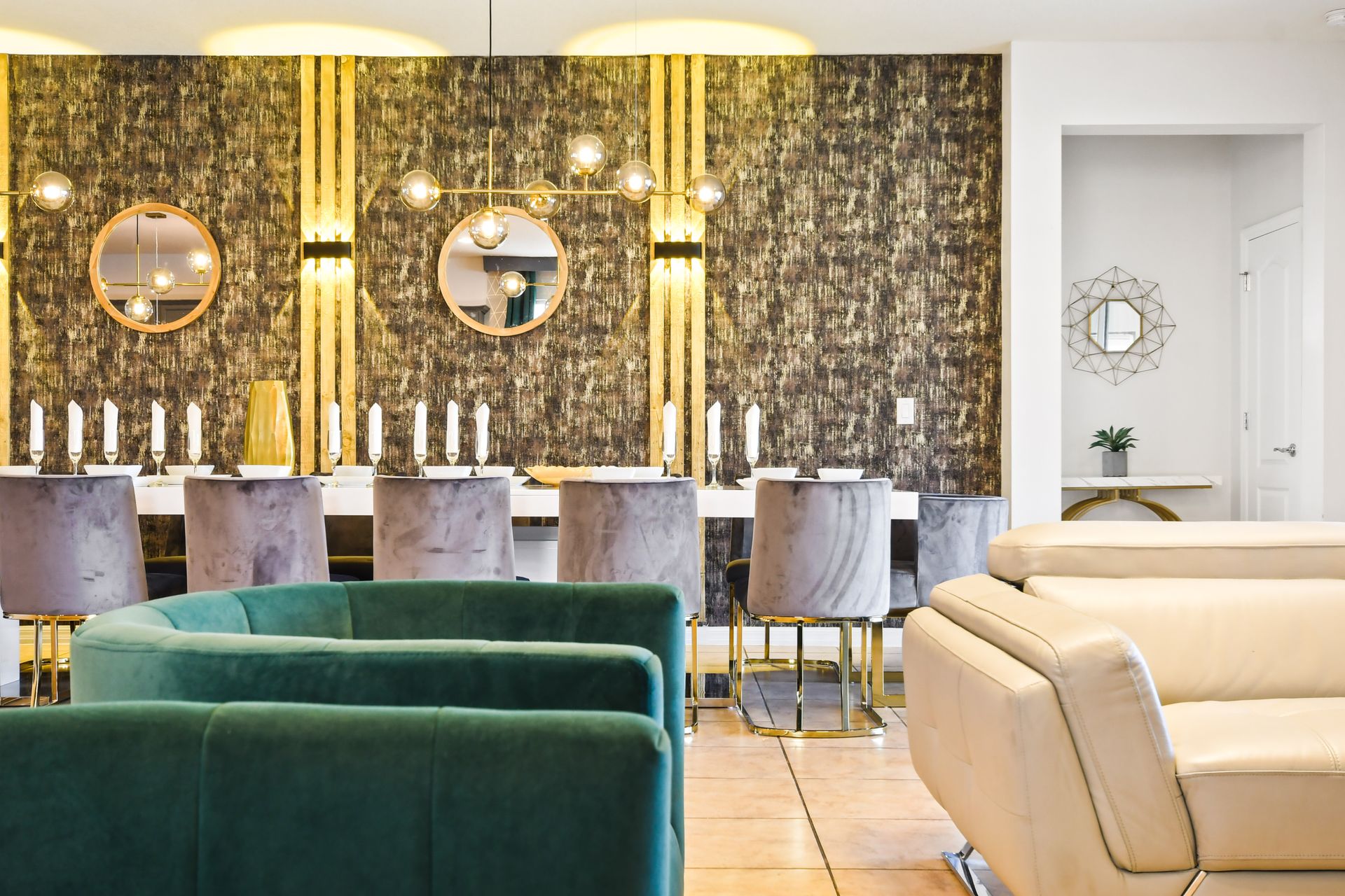 Chic dining area with velvet chairs, golden accents, and warm ambient lighting.