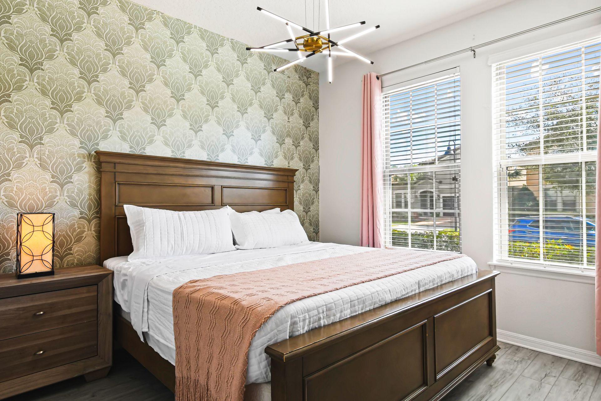 Cozy queen bedroom with soft natural light and elegant golden accents throughout.