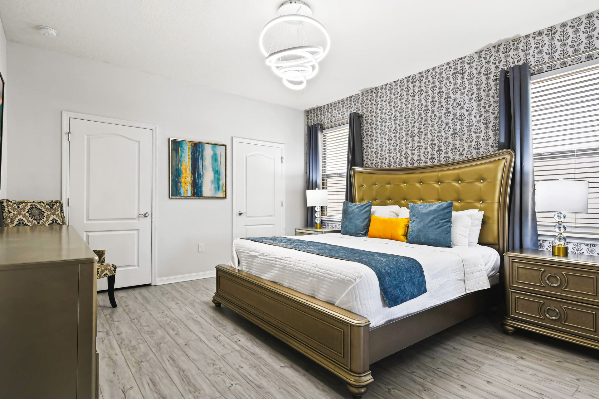 Elegant king bedroom with gold accents, bold textures, and stylish comfort.