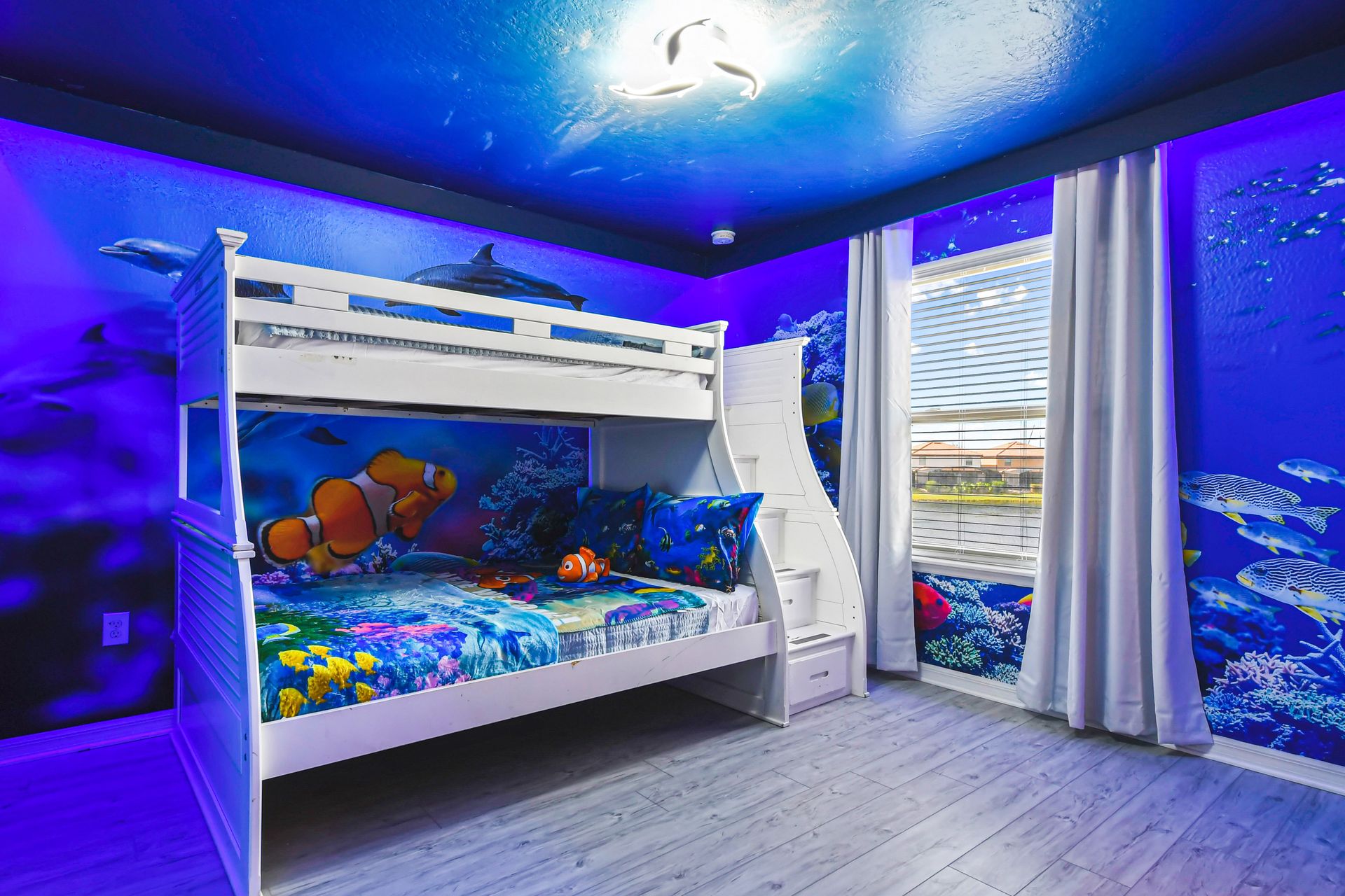 Ocean-themed bunk room with vibrant sea life walls and fun undersea décor.