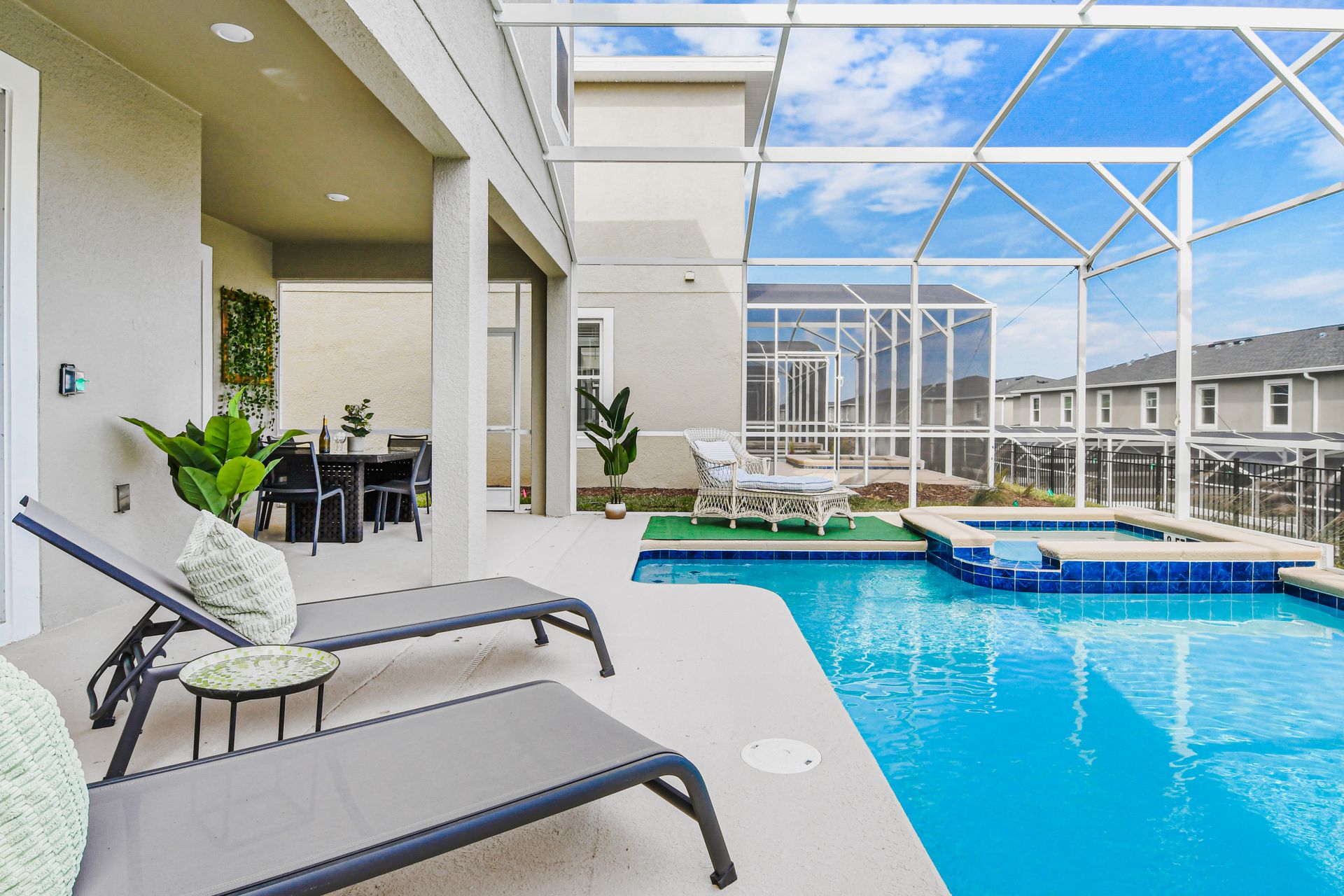 Private poolside retreat with loungers, dining area, and screened-in patio comfort.
