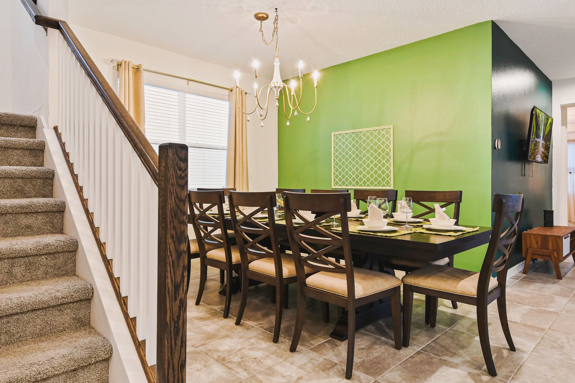 Elegant dining room with seating for eight, warm lighting, and a fresh green accent.