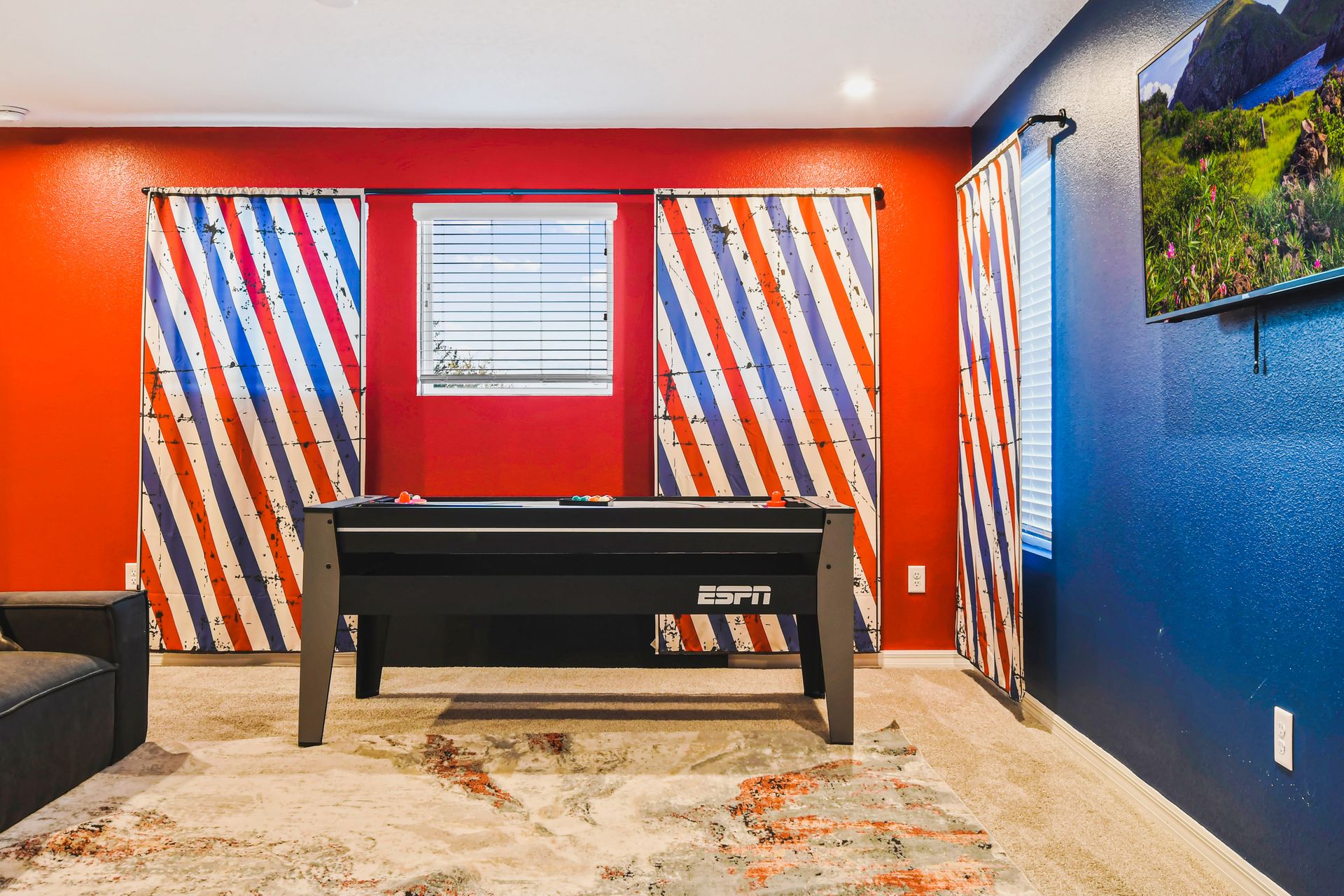 Vibrant game room with pool table, bold colors, and a cozy spot to unwind.