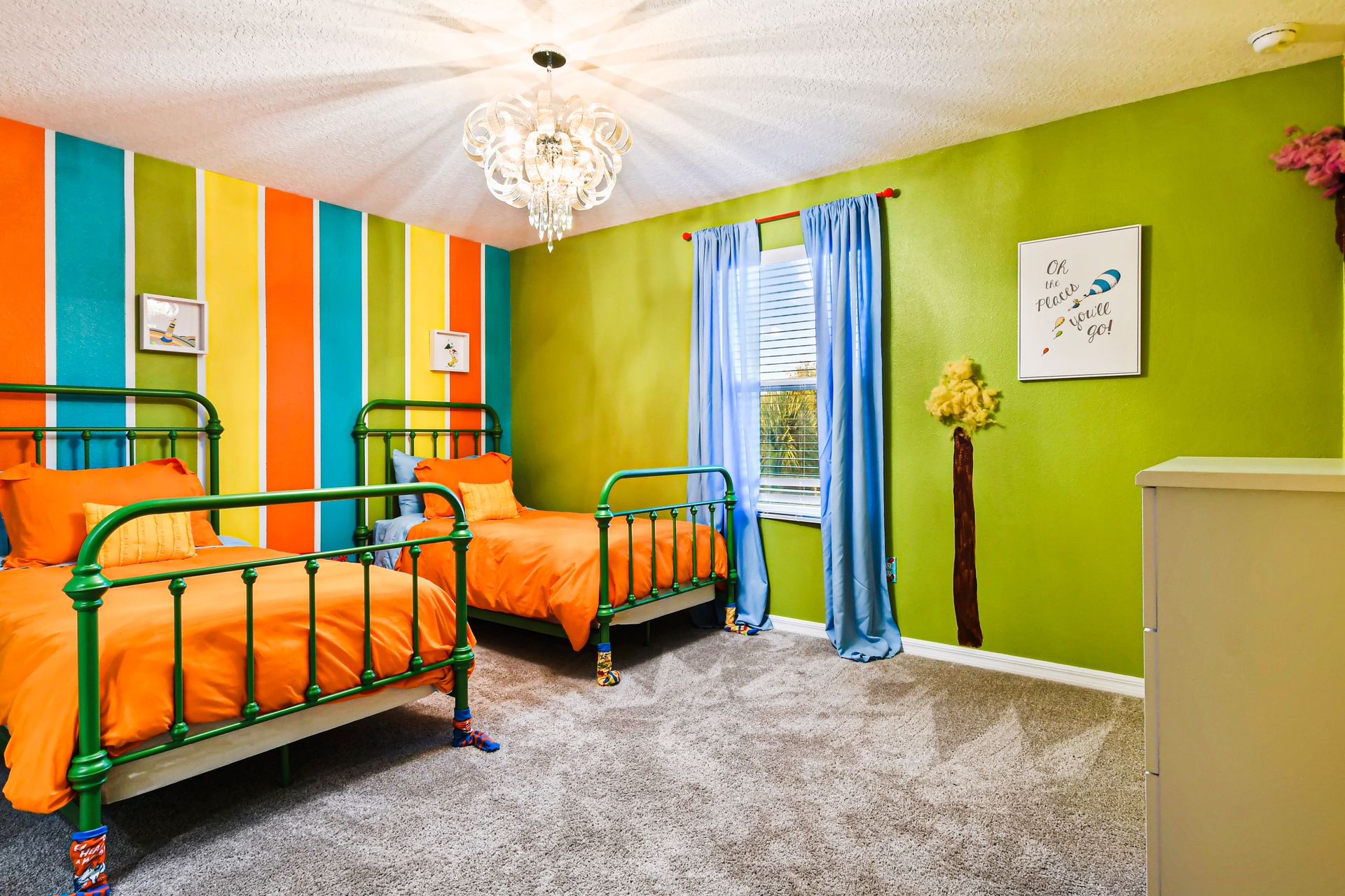 Colorful kids' room with vibrant stripes, playful decor, and cozy twin beds.