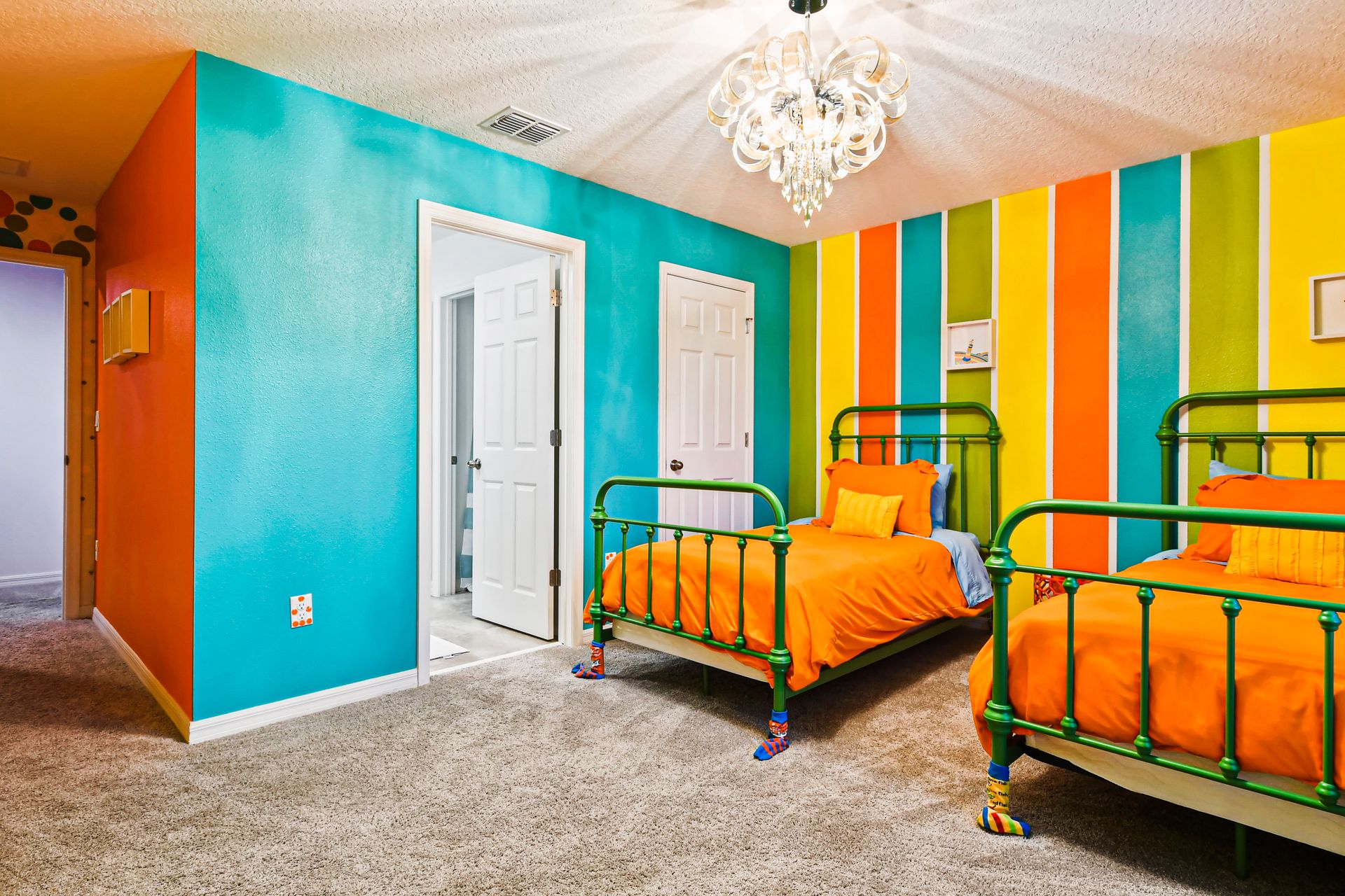 Colorful kids' room with vibrant stripes, playful decor, and cozy twin beds.