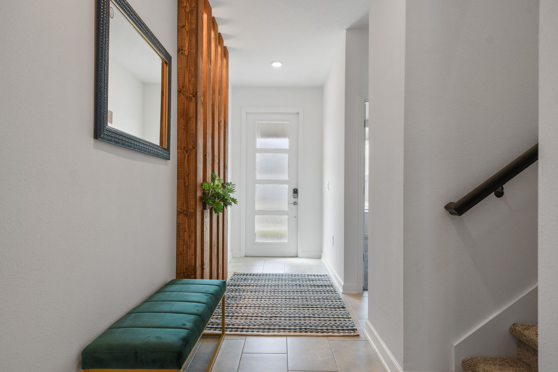 Elegant hallway with plush bench, wood panel feature, and soft lighting.