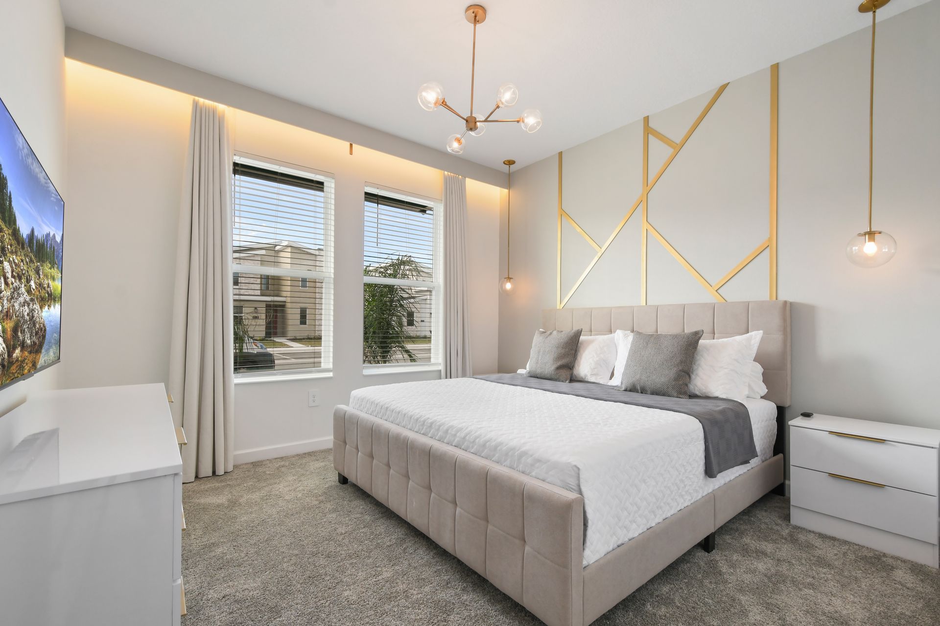 Modern glam bedroom with gold accents, soft neutrals, and stylish lighting touches.