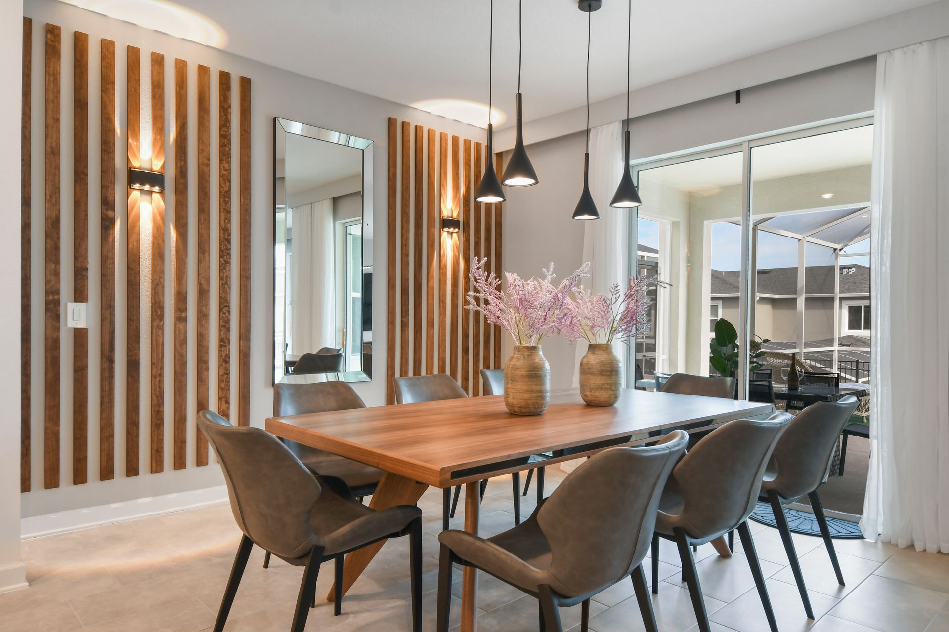 Elegant dining area with modern lighting, sleek seating, and natural wood touches.
