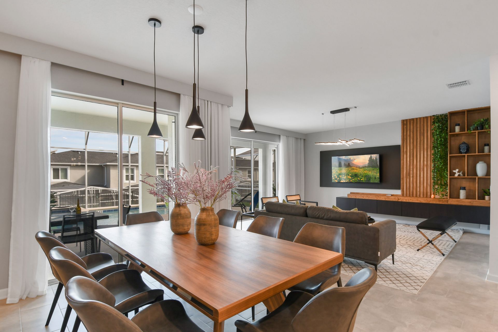 Open-concept dining and living space with modern design and warm natural finishes.
