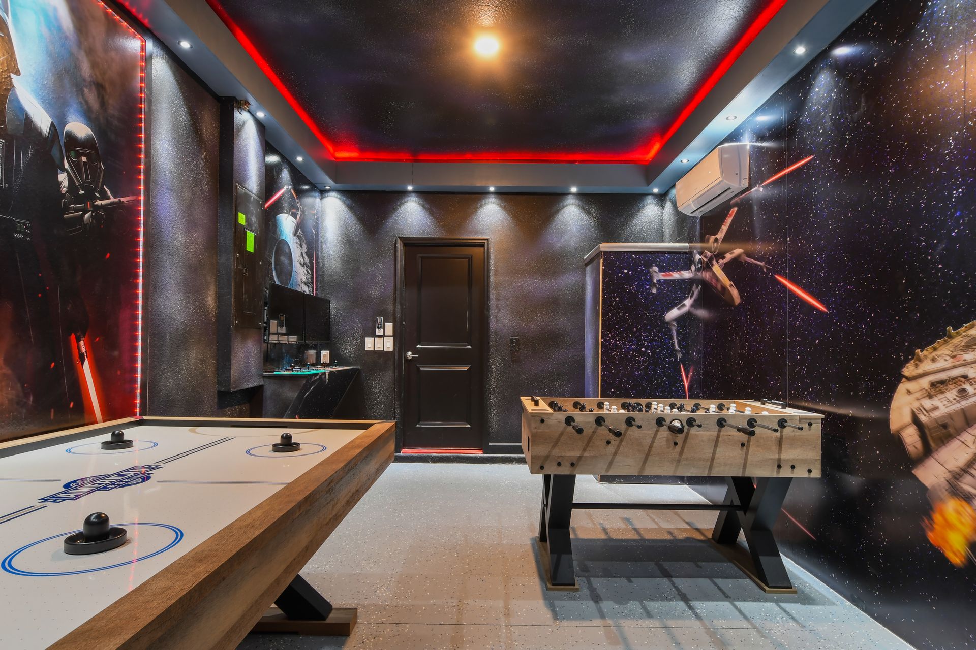Galactic game room with Star Wars flair, air hockey, foosball, and arcade fun.