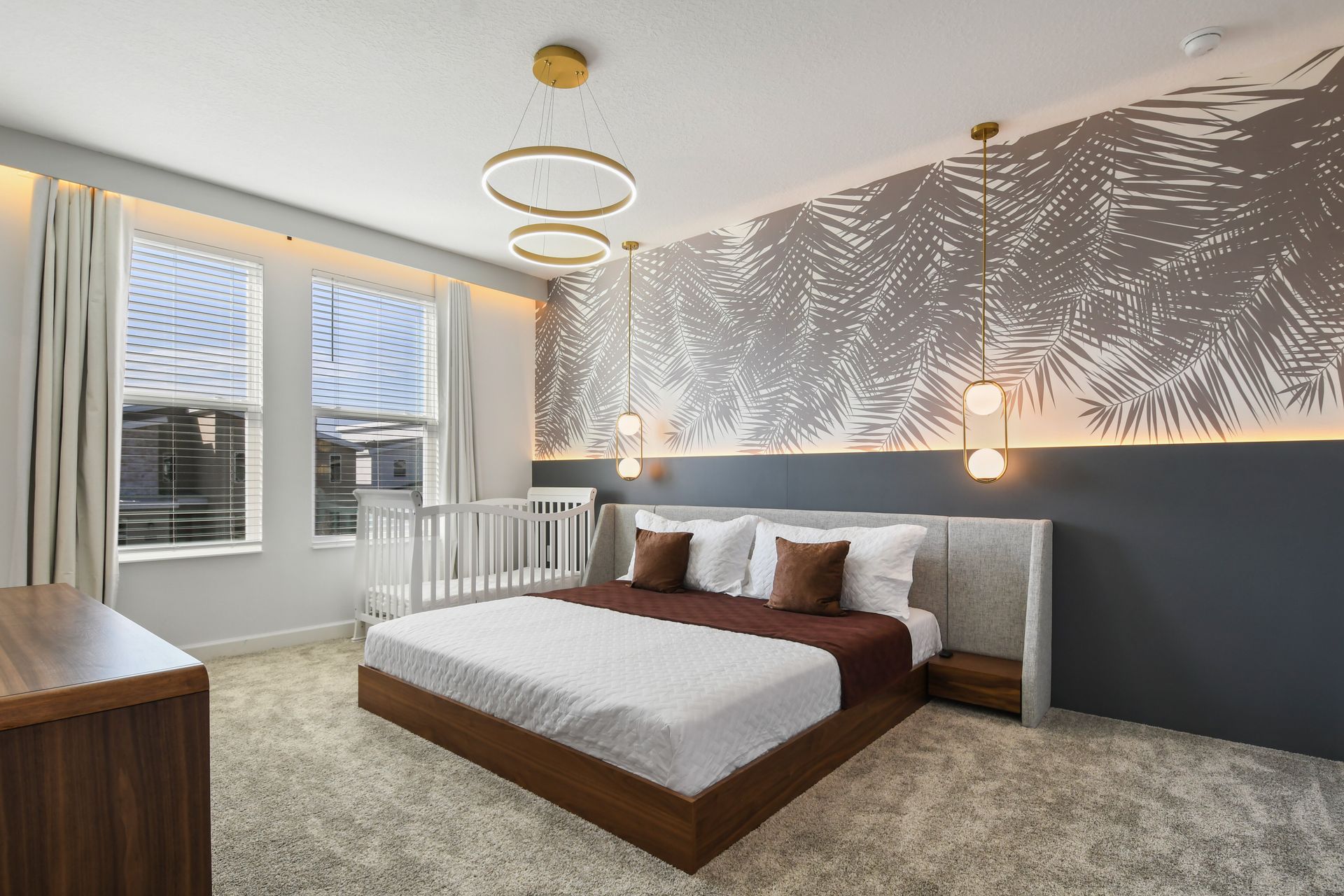 Stylish master bedroom with modern décor, ambient lighting, and a cozy crib nook.