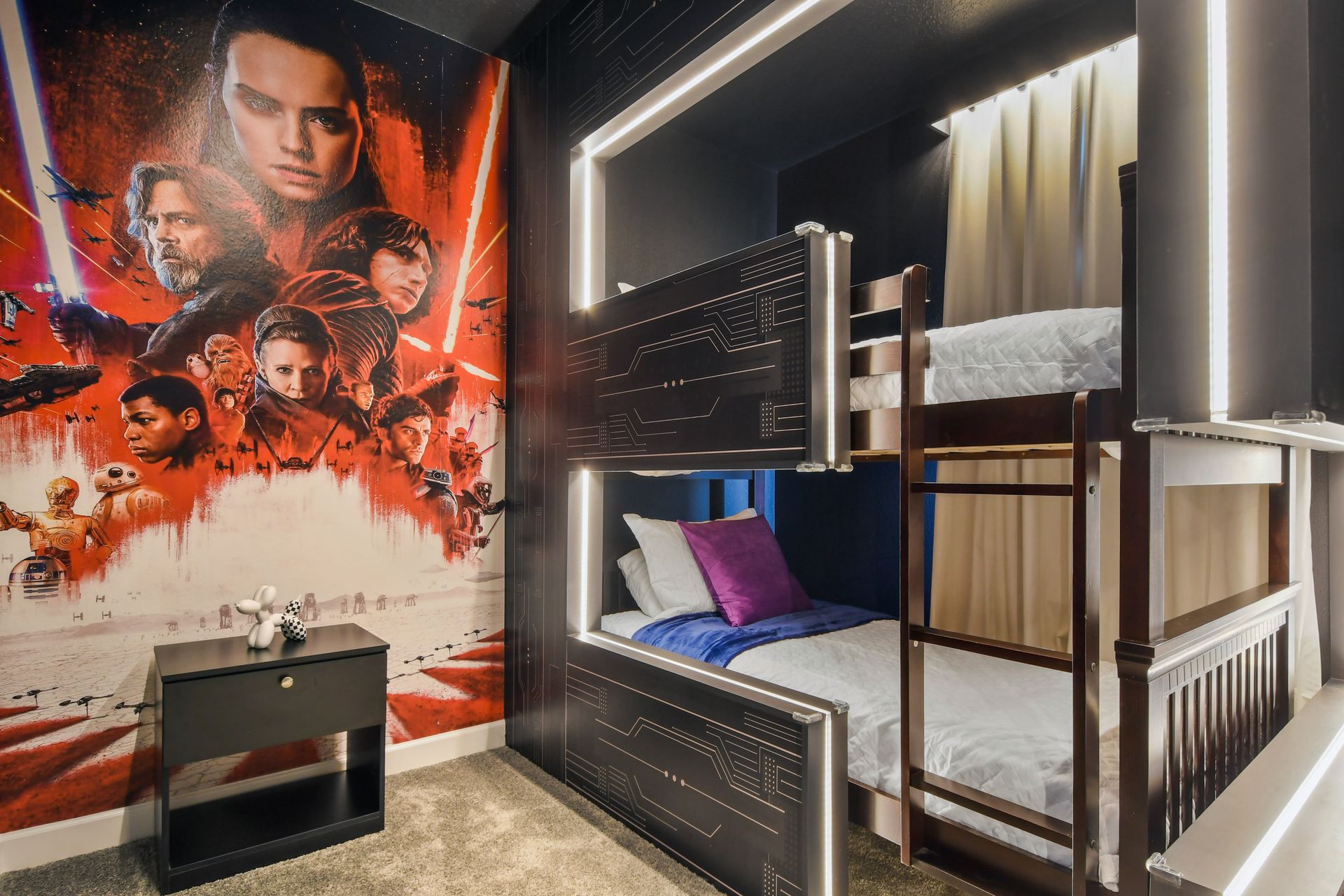 Futuristic Star Wars-themed bunk room with glowing lights and epic mural.