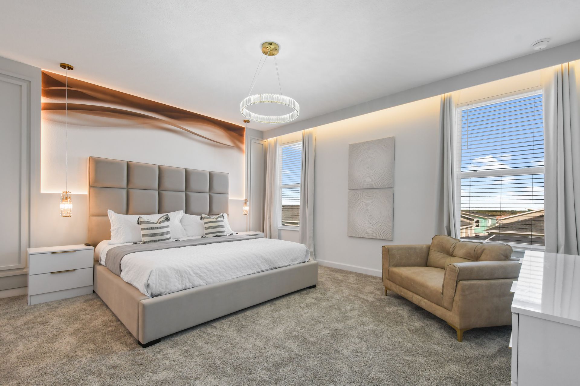 Luxurious king suite with elegant lighting, plush seating, and modern wall art.
