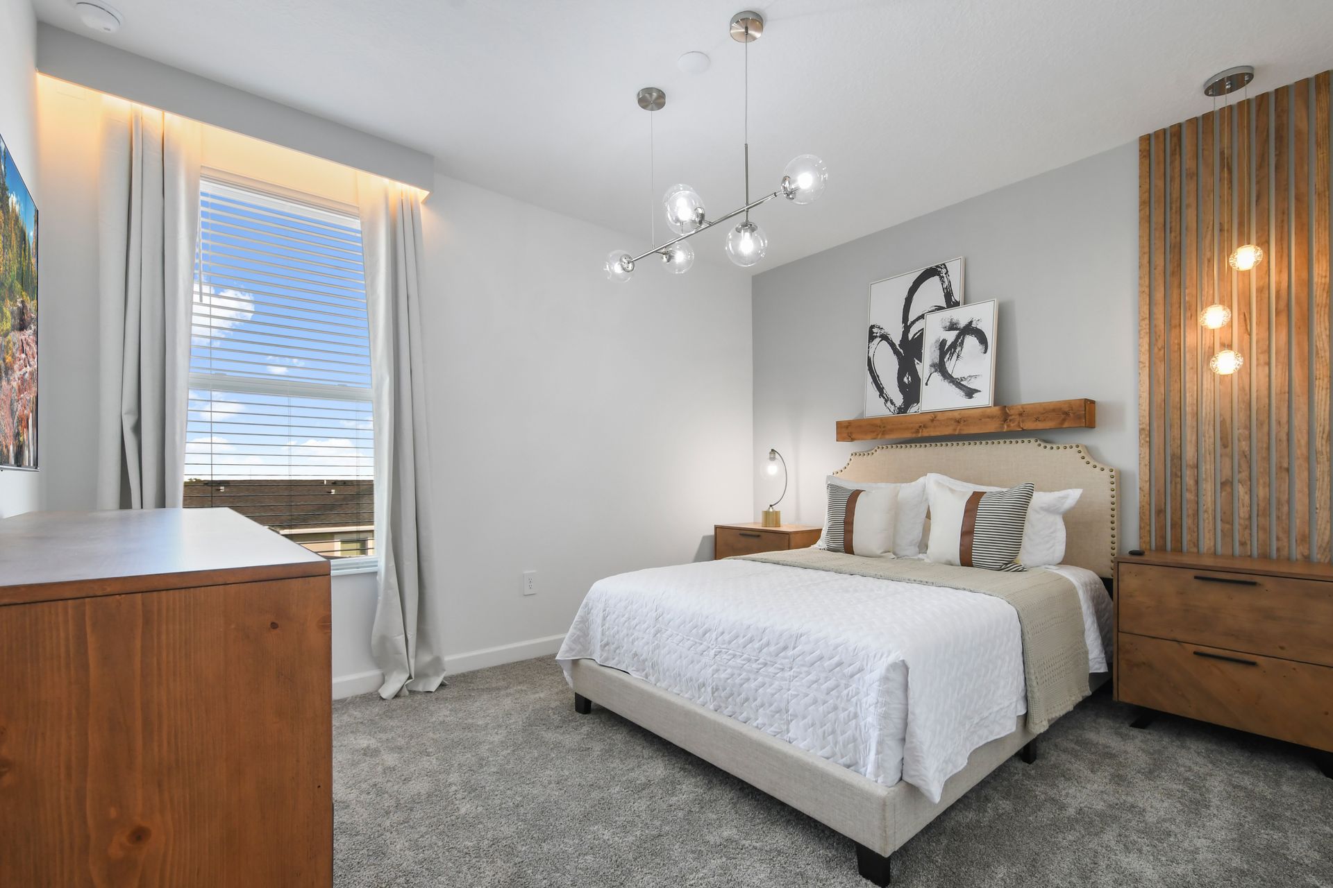 Cozy modern bedroom with wood accents, abstract art, and soft ambient lighting.
