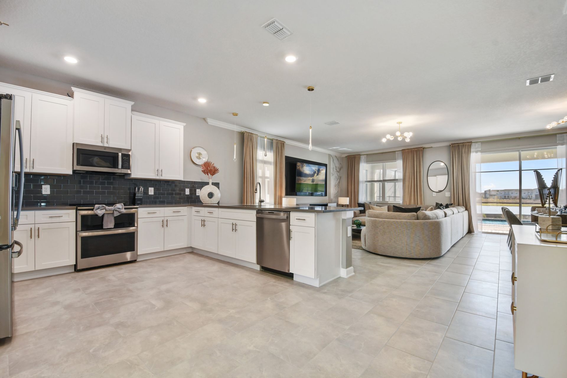 Spacious open-concept kitchen and living area with lake views and designer touches.