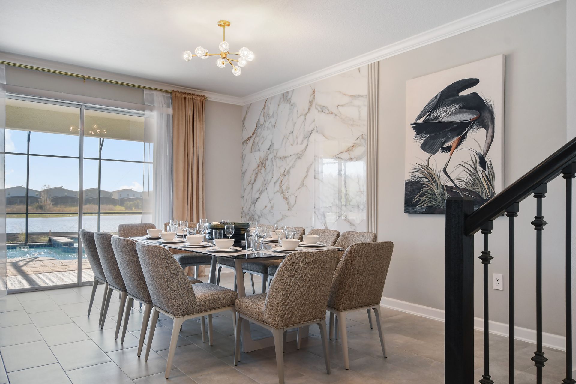 Elegant dining space with marble accent wall and lake views for memorable meals.