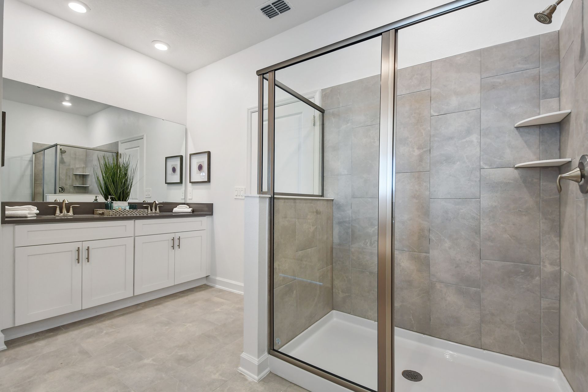 Modern ensuite with spacious walk-in shower, dual vanity, and sleek neutral finishes.