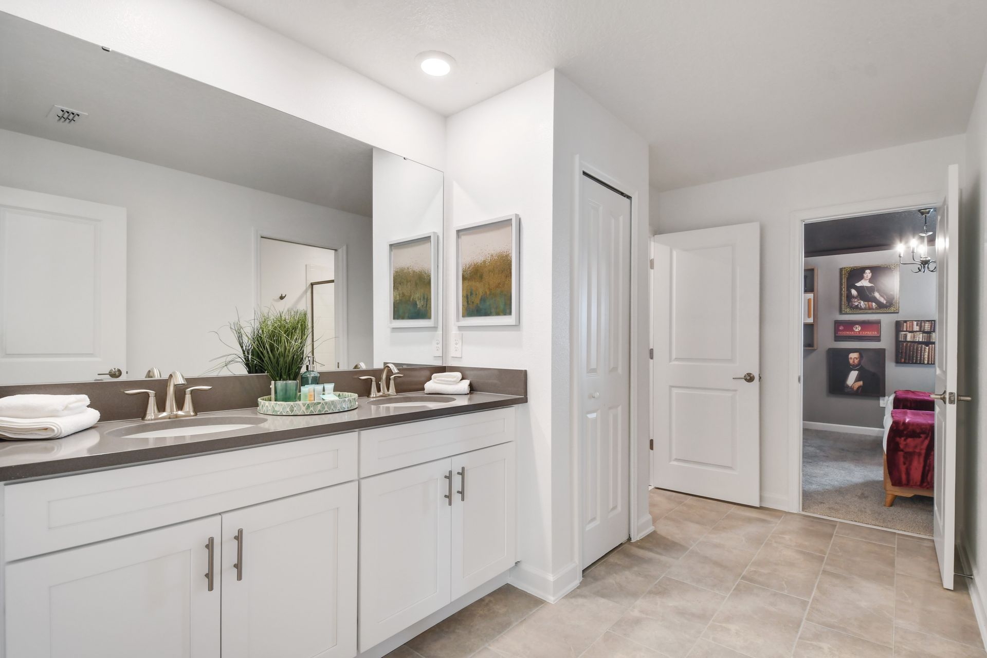 Chic dual-sink bathroom with modern decor and easy access to themed bedrooms.