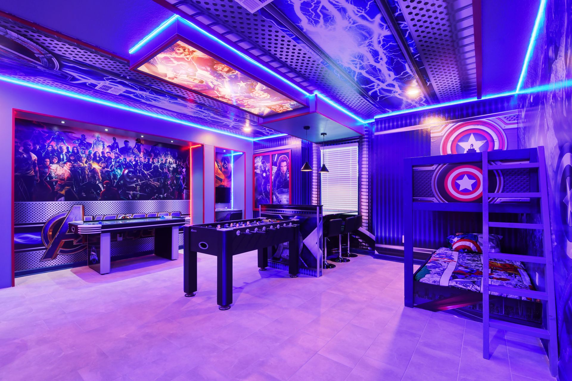 Avengers-themed game room with bunk beds, foosball, and epic superhero decor.