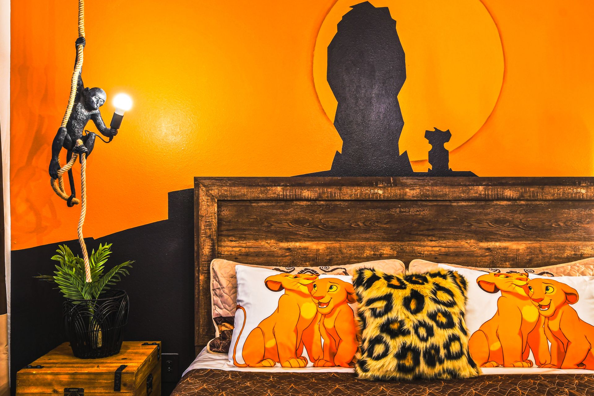 Safari-style Lion King room with sunset mural and warm, wild-hearted charm.