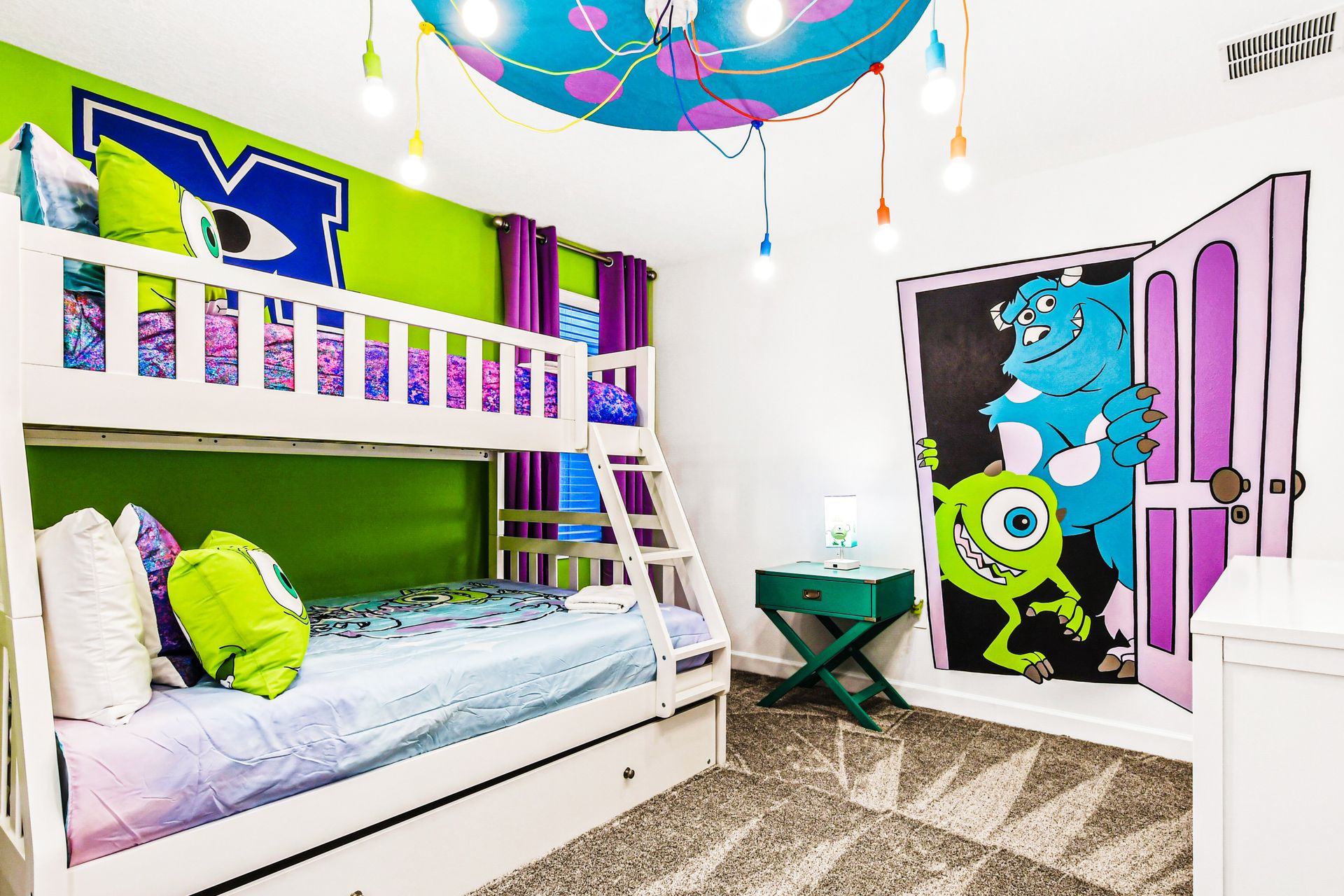 Monsters, Inc. themed kids’ room with vibrant colors and fun bunk bed setup.