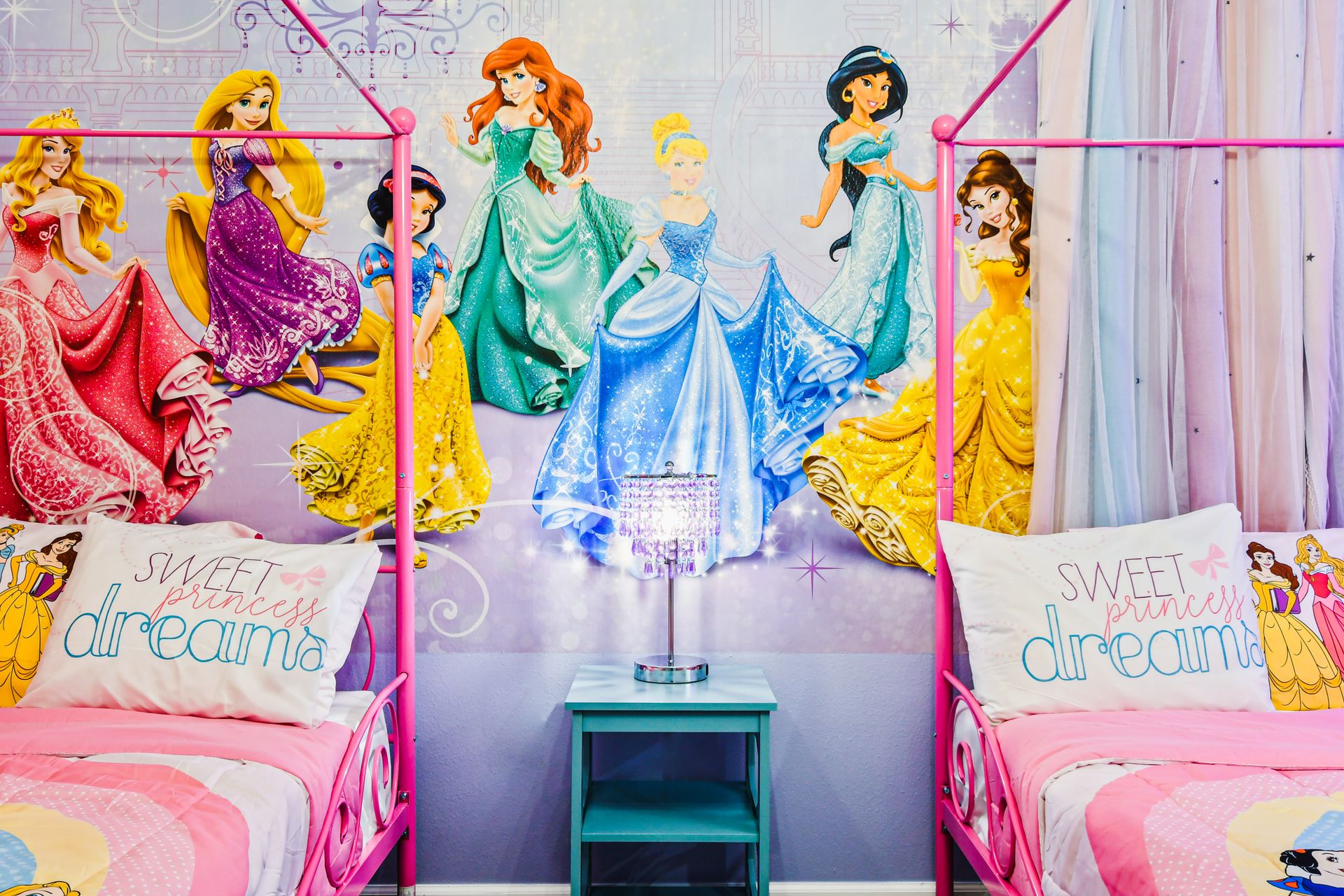 Enchanting princess haven with sparkling wall art and dreamy twin canopy beds.