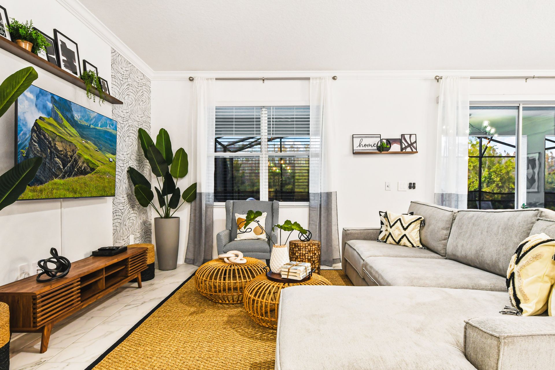 Cozy living space with bold greenery, modern accents, and a sleek TV setup.