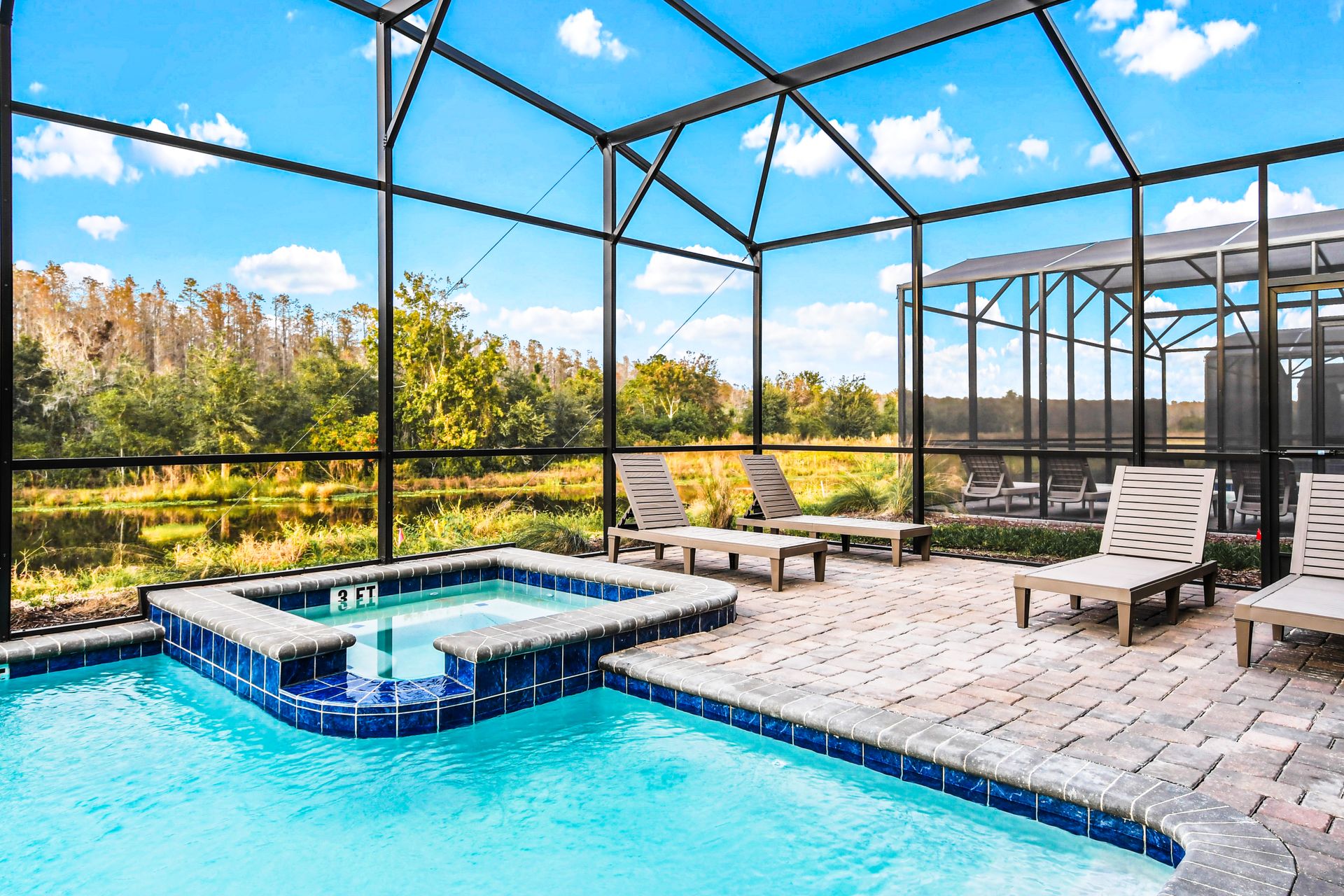 Private screened pool and spa with peaceful nature views and sunny lounge space.