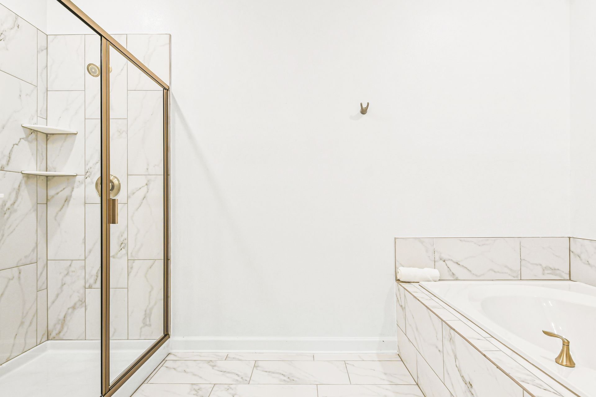 Elegant spa-style bathroom with walk-in shower, soaking tub, and marble finishes.