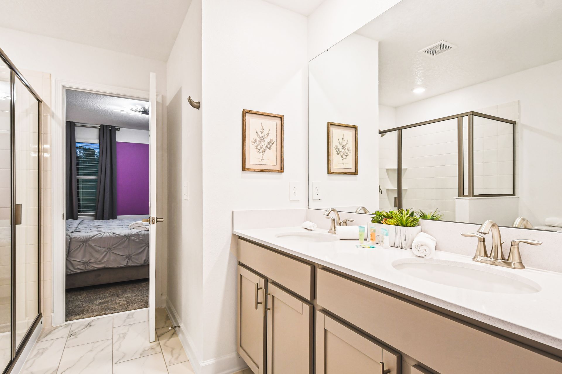 Jack-and-Jill bathroom with double vanity, walk-in shower, and sleek design.