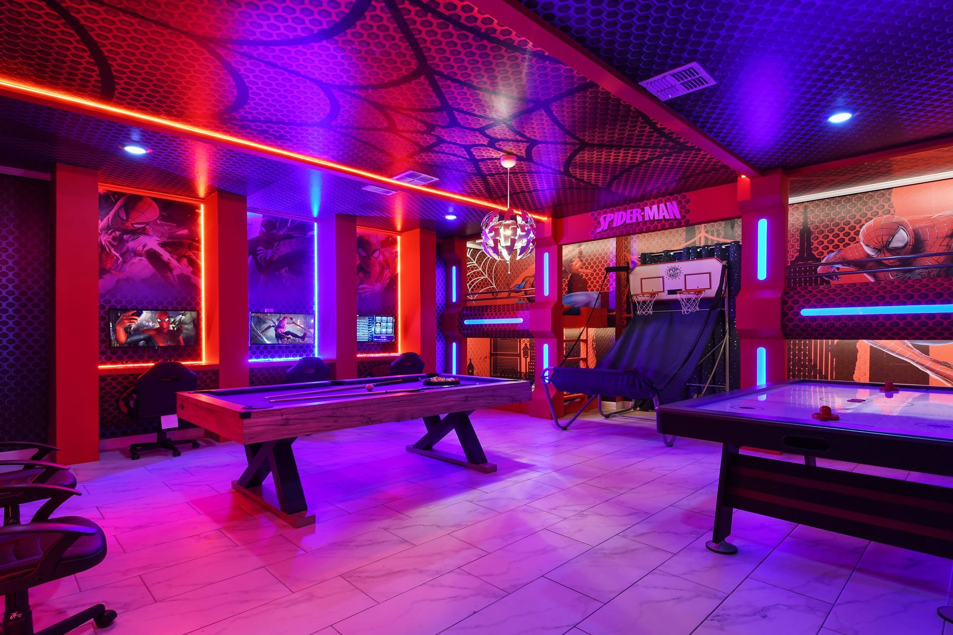 Epic Spider-Man game room with pool table, dual gaming setups, and neon vibes.