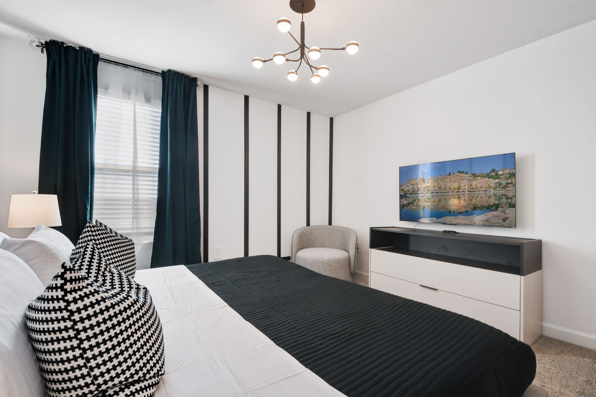 Modern king suite with bold accents, luxe bedding, and a smart TV for relaxing.