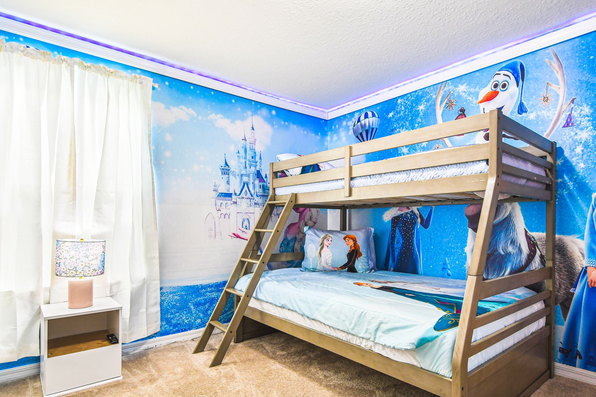 Dreamy Frozen-themed bedroom with enchanting murals, where magical winter tales come to life for any young adventurer!