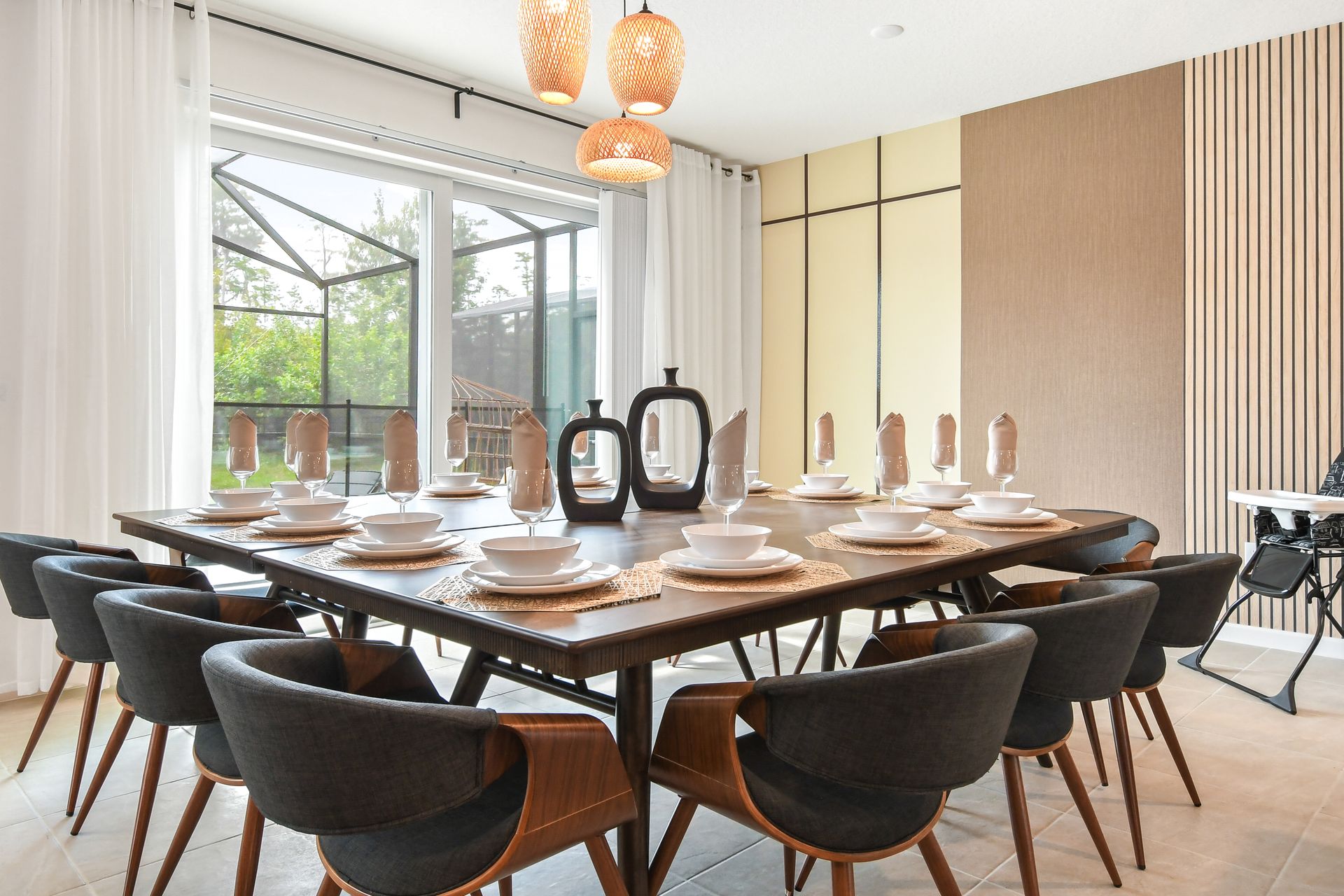 Elegant dining room with a spacious table, modern decor, and warm natural lighting.