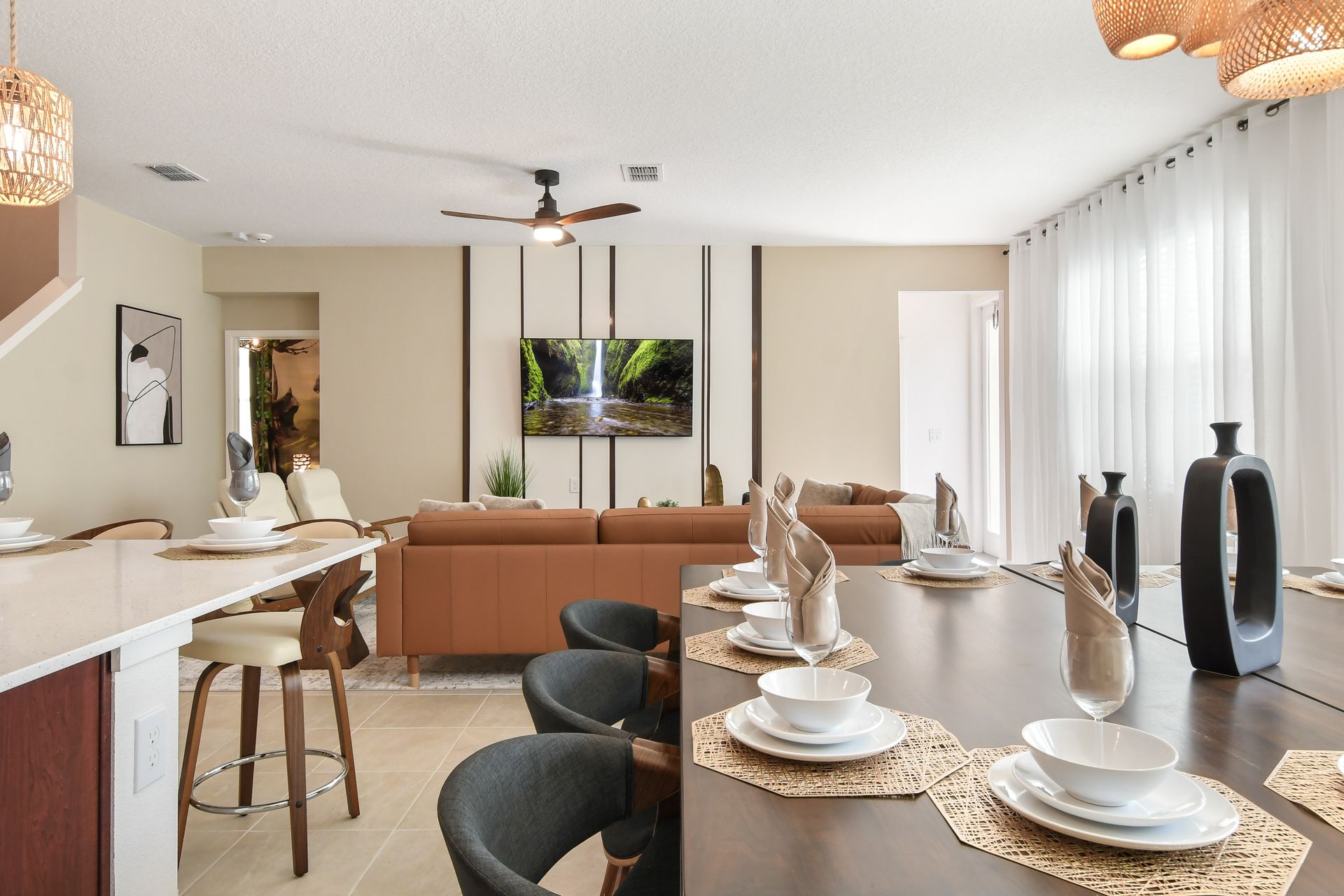 Open-concept living space with a modern dining area, stylish kitchen, and cozy seating.